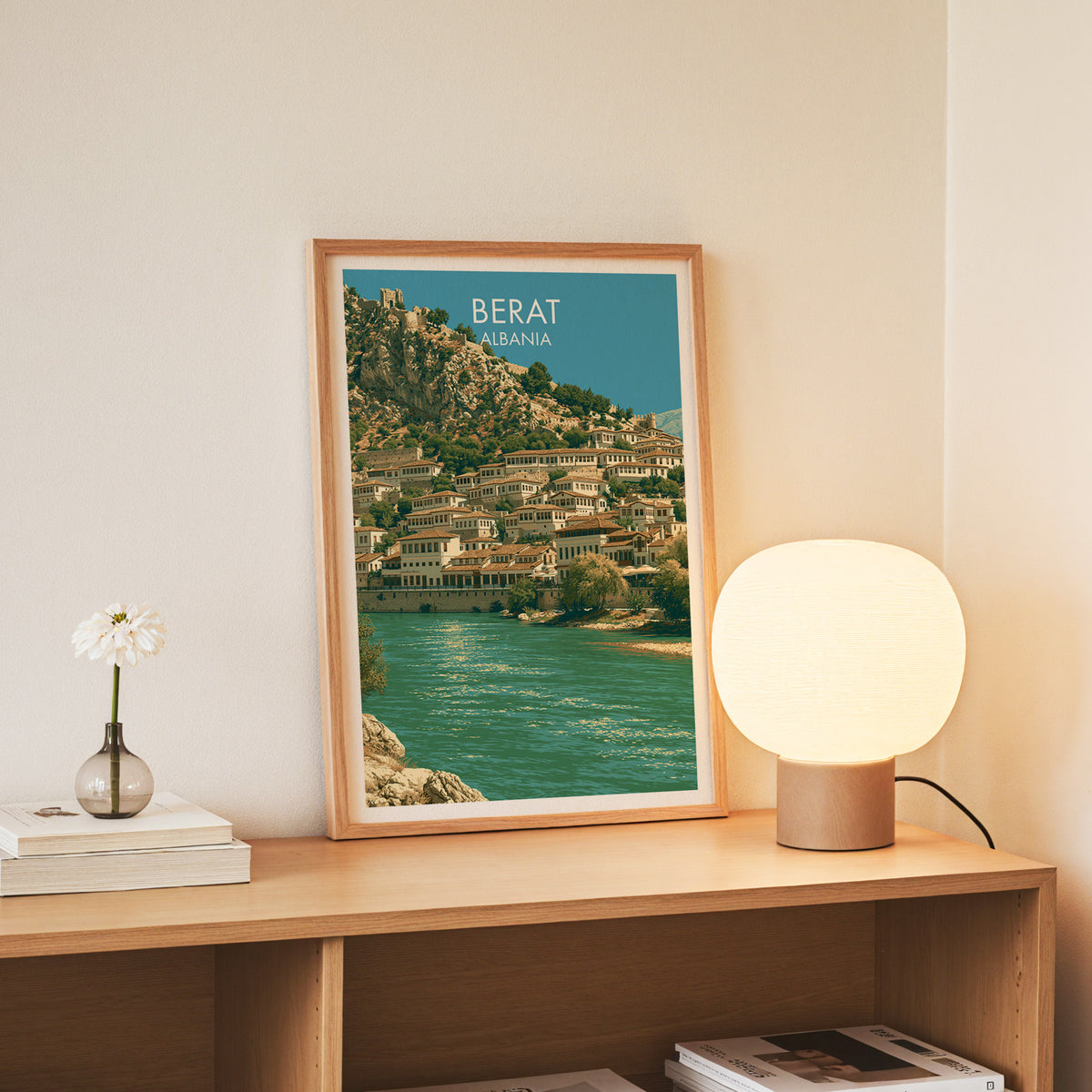 Berat Albania wall art, slim oak frame standing on an oak console beside a daisy in a glass bottle