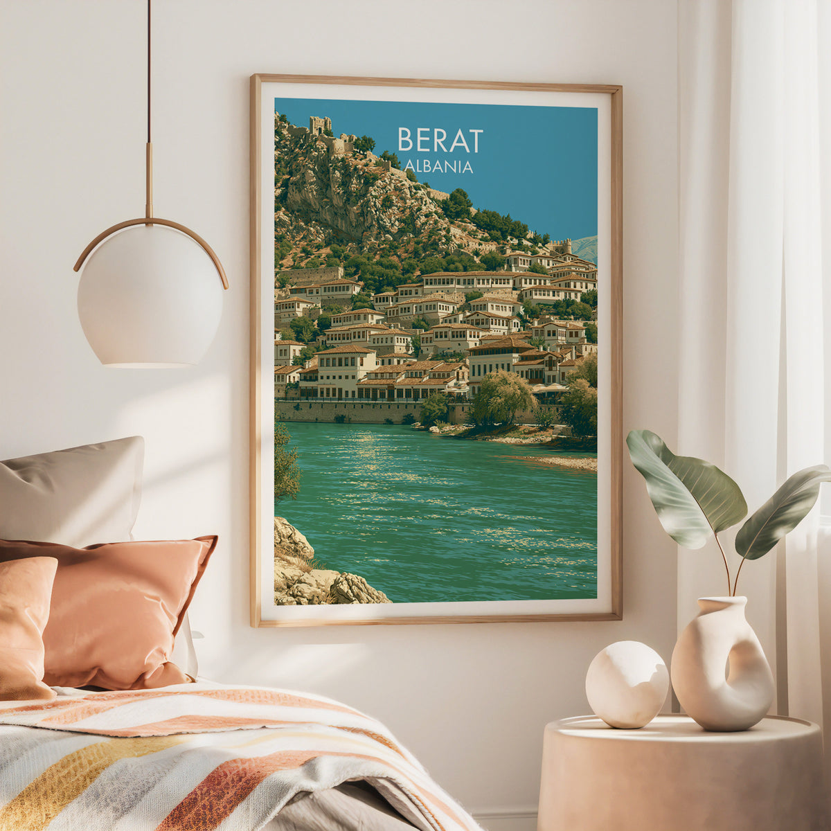 Berat Albania wall art, large oak frame above a bed with rust bedding and a brass globe pendant