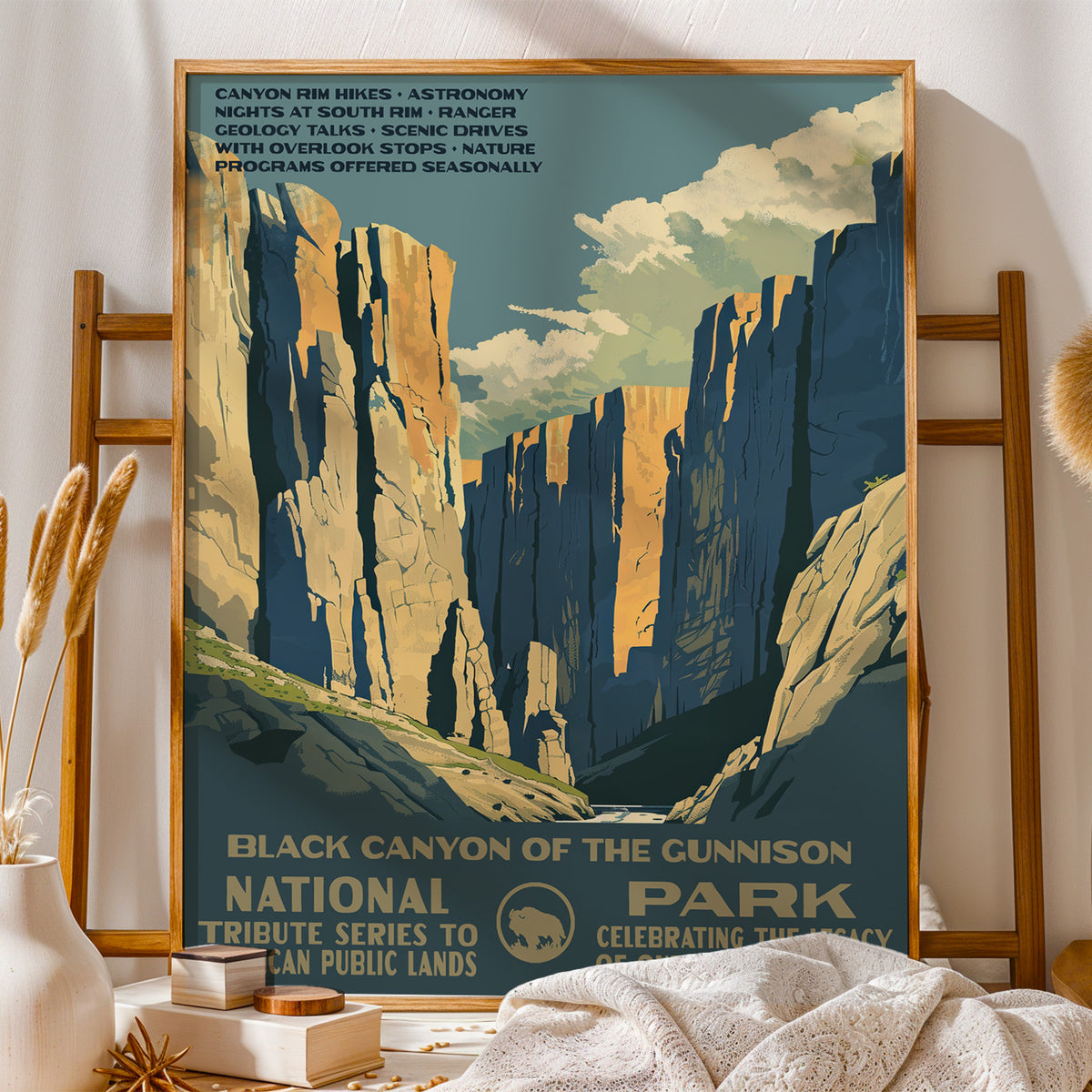 Black Canyon of the Gunnison National Park vintage print on a wooden stand with folded blankets and books