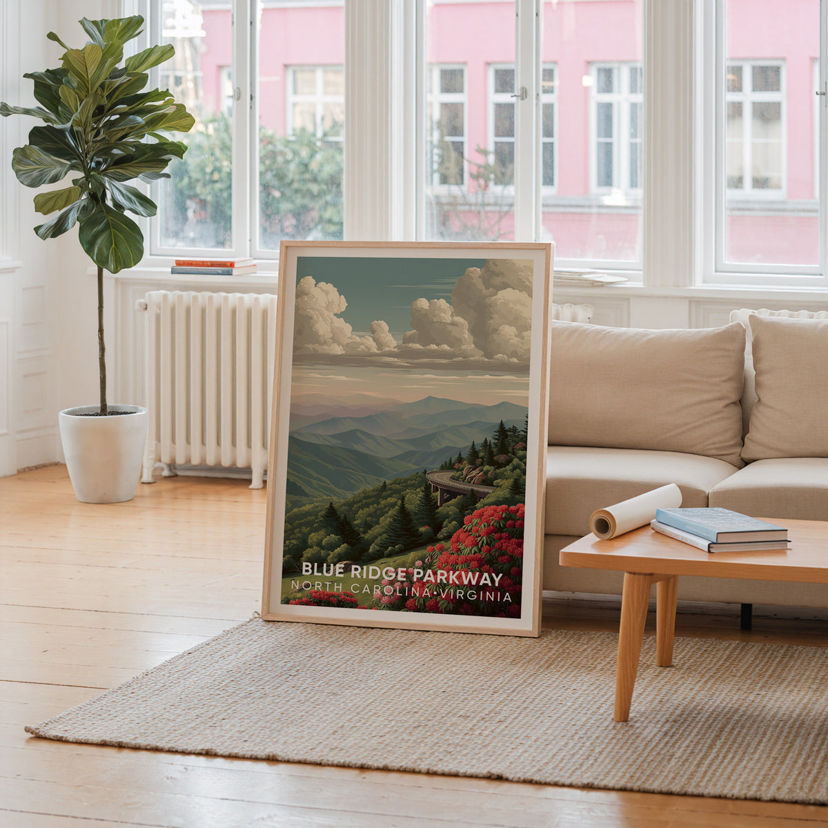 Blue Ridge Parkway wall art in oak by a window framing a pink facade, cream sofa and radiator behind
