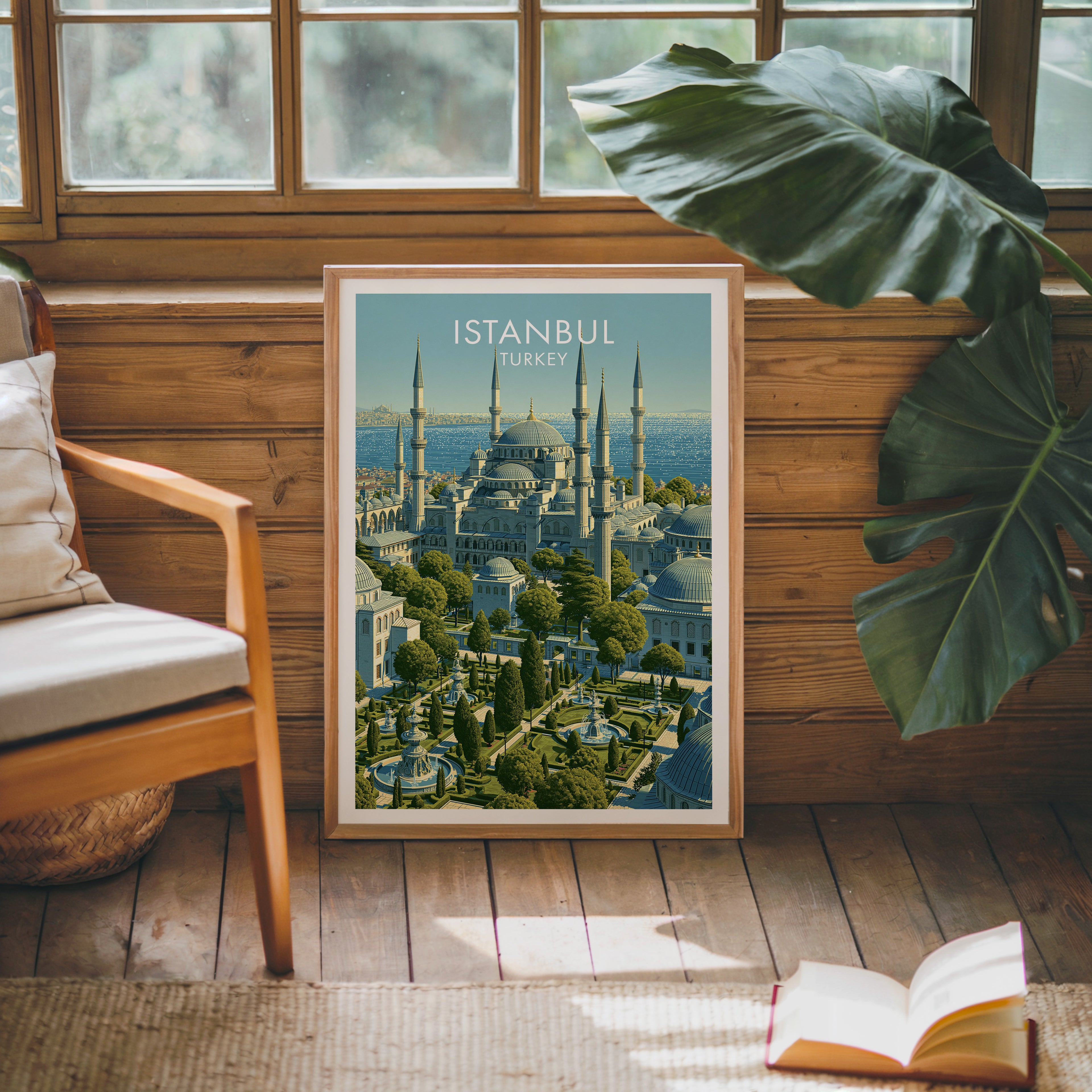 Framed Blue Mosque Istanbul Turkey poster leaning against a timber cabin wall with monstera leaves and an open book