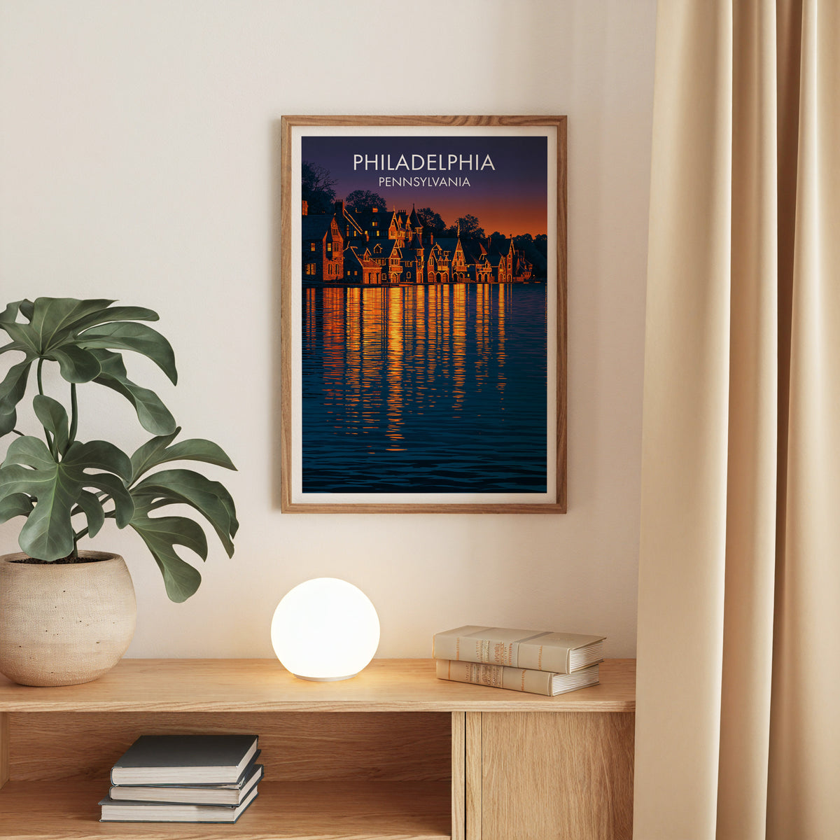 Philadelphia night poster in an oak frame on a beige wall above an oak console with a monstera
