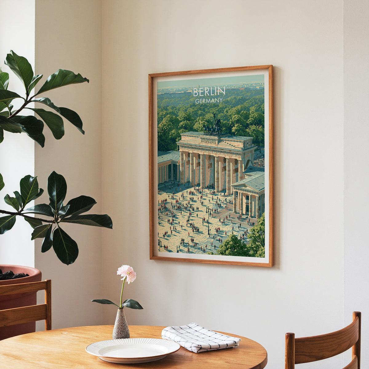 Brandenburg Gate poster, walnut frame in a dining corner above a round table and a fiddle-leaf fig