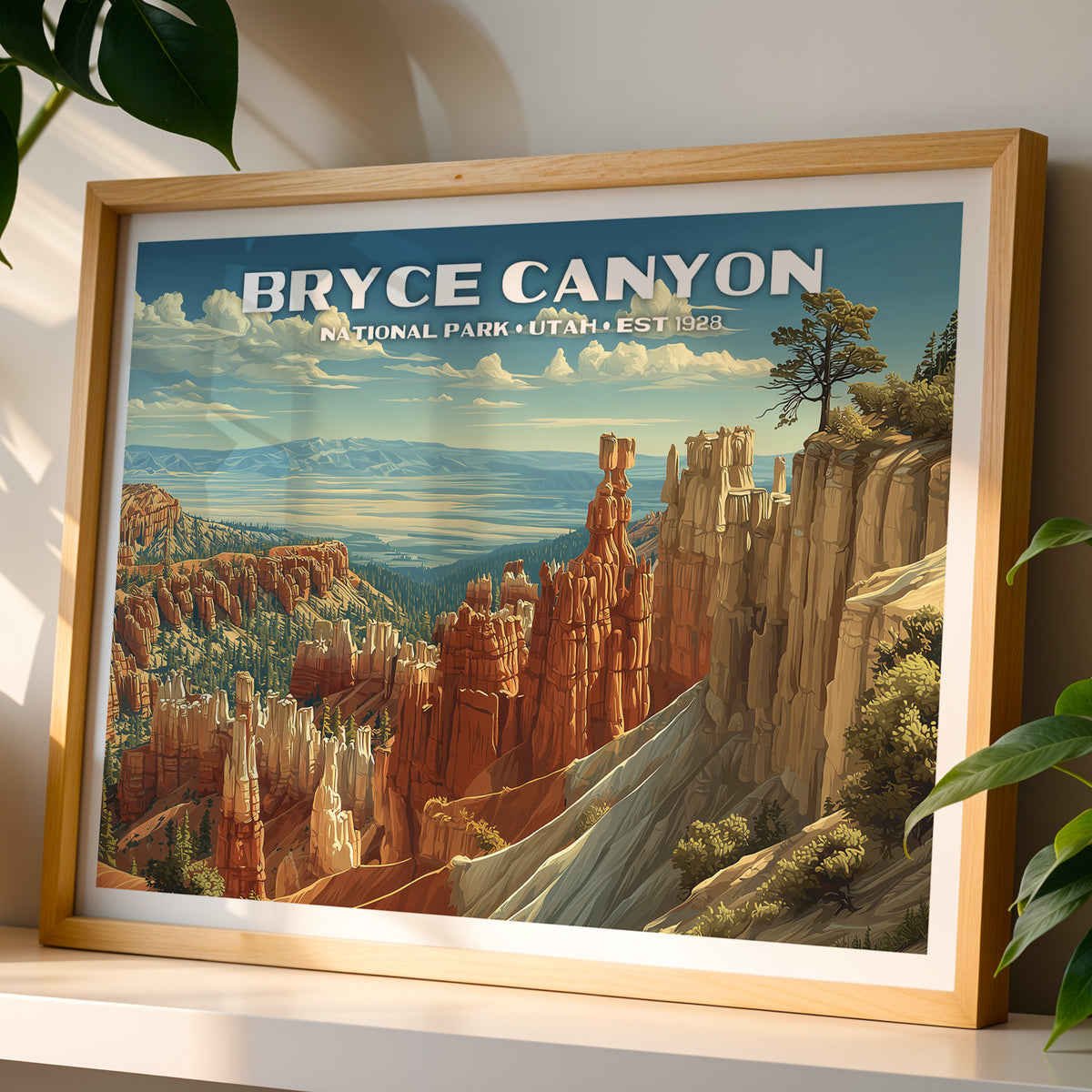 Bryce Canyon National Park wall art print in a light oak frame, leaning on a white shelf in warm sunlight beside a monstera plant