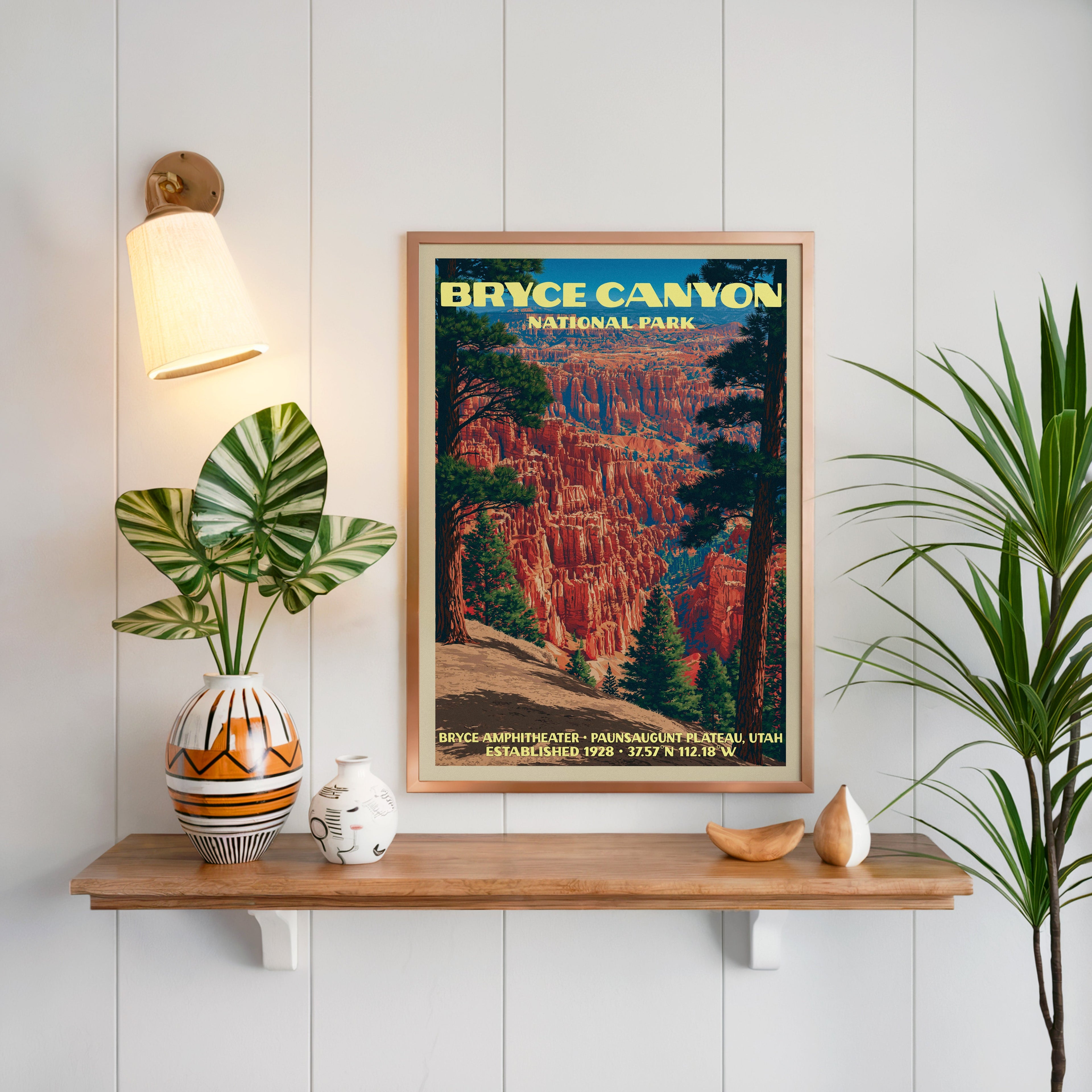Bryce Amphitheater print framed on white panelling above an oak shelf with a patterned vase and sconce