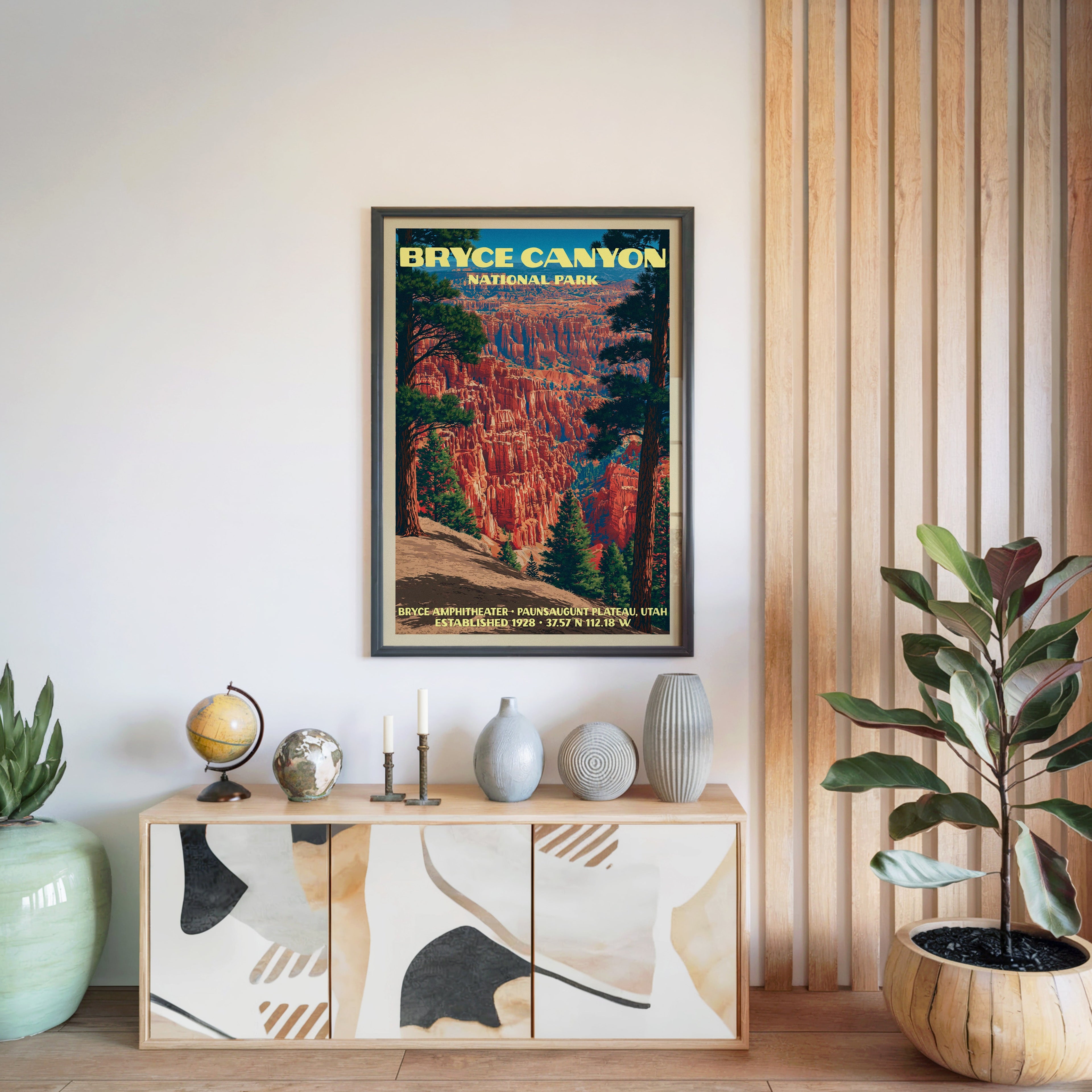 Bryce Canyon National Park poster in a black frame above a light wood sideboard by a slatted panel