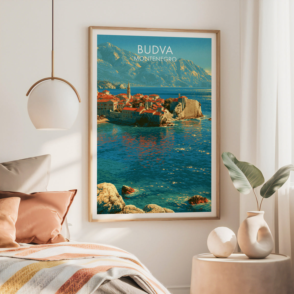 Budva Montenegro wall art, large oak frame above a bed with rust bedding and a brass globe pendant