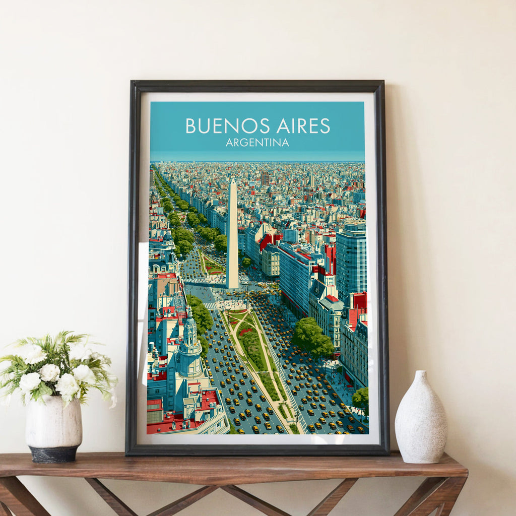 Obelisco print in a black frame on a brown console table with white flowers in a ceramic vase