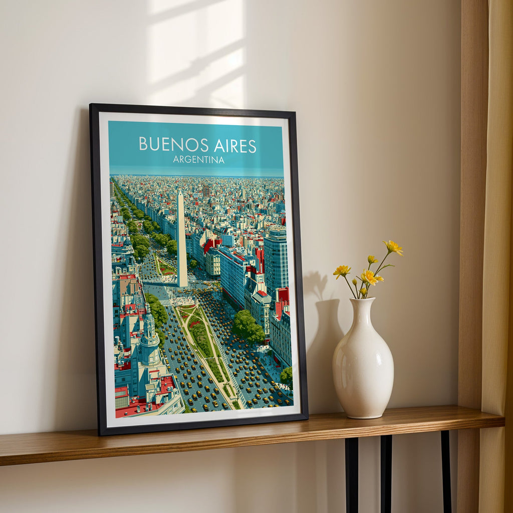 Argentina city wall art in a black frame on a narrow wood shelf with yellow daisies in a white vase