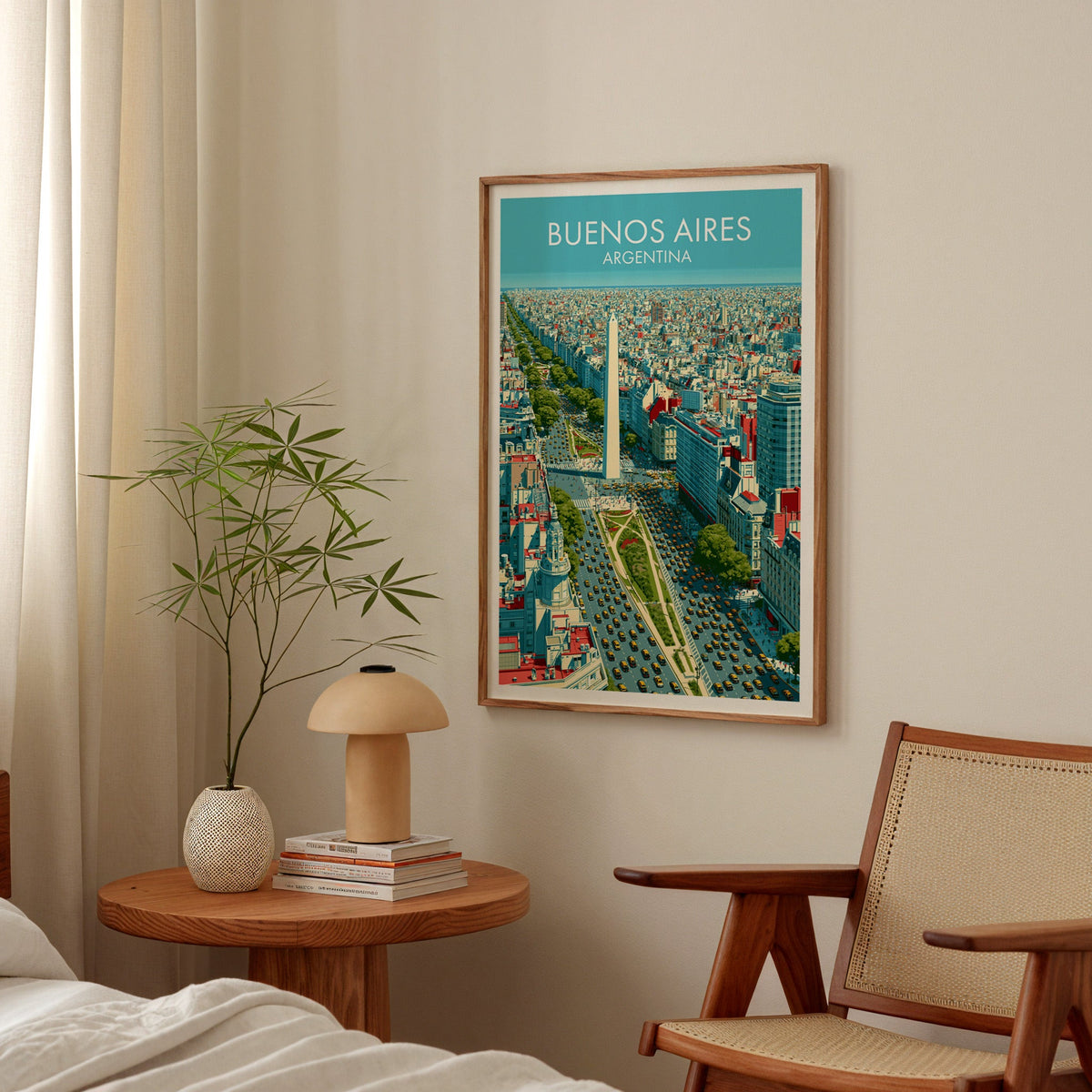 Cyan and yellow city poster in a walnut frame in a bedroom above a round nightstand with a mushroom lamp