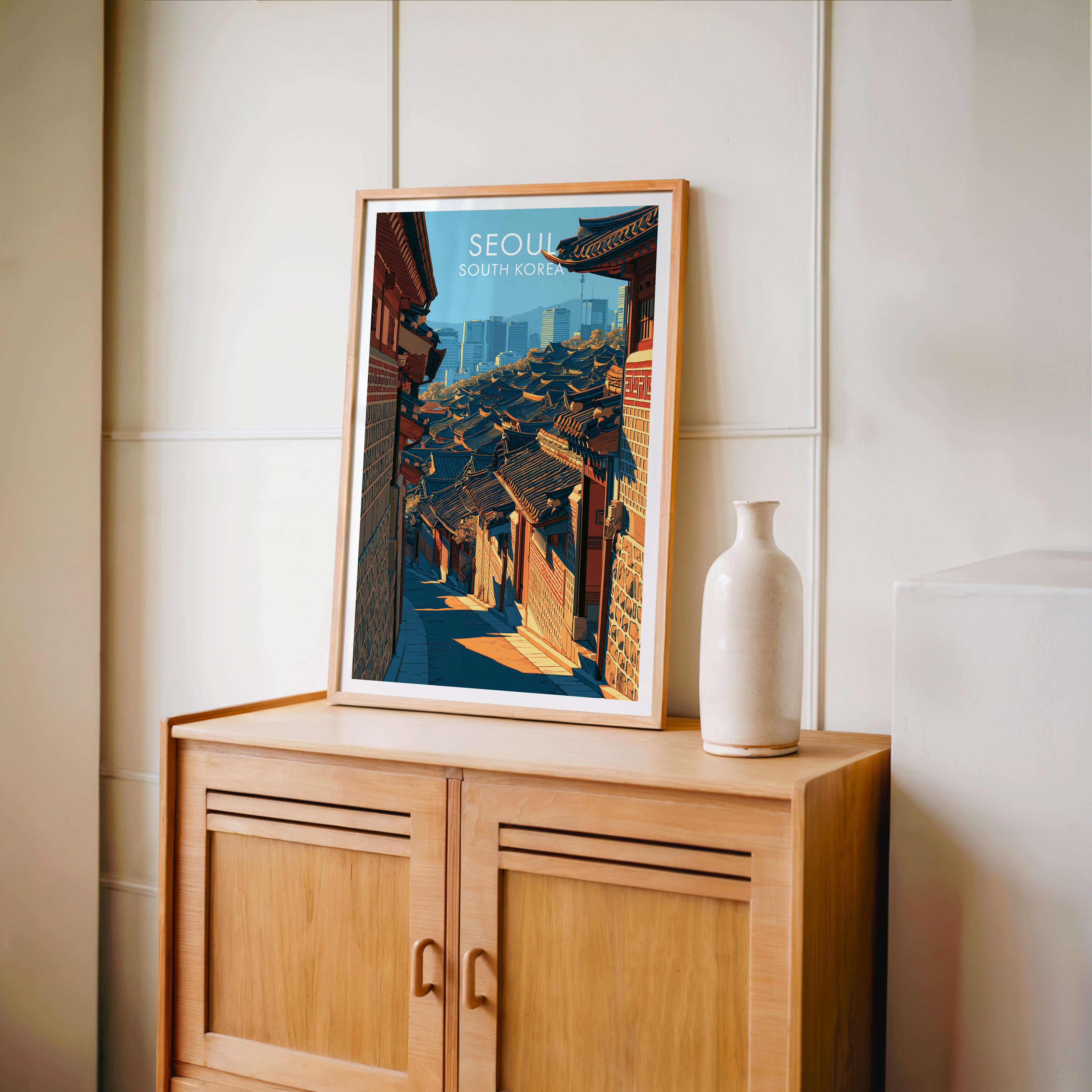 Small Bukchon Hanok Village Seoul travel poster in an oak frame on a mid-century sideboard with a ceramic vase