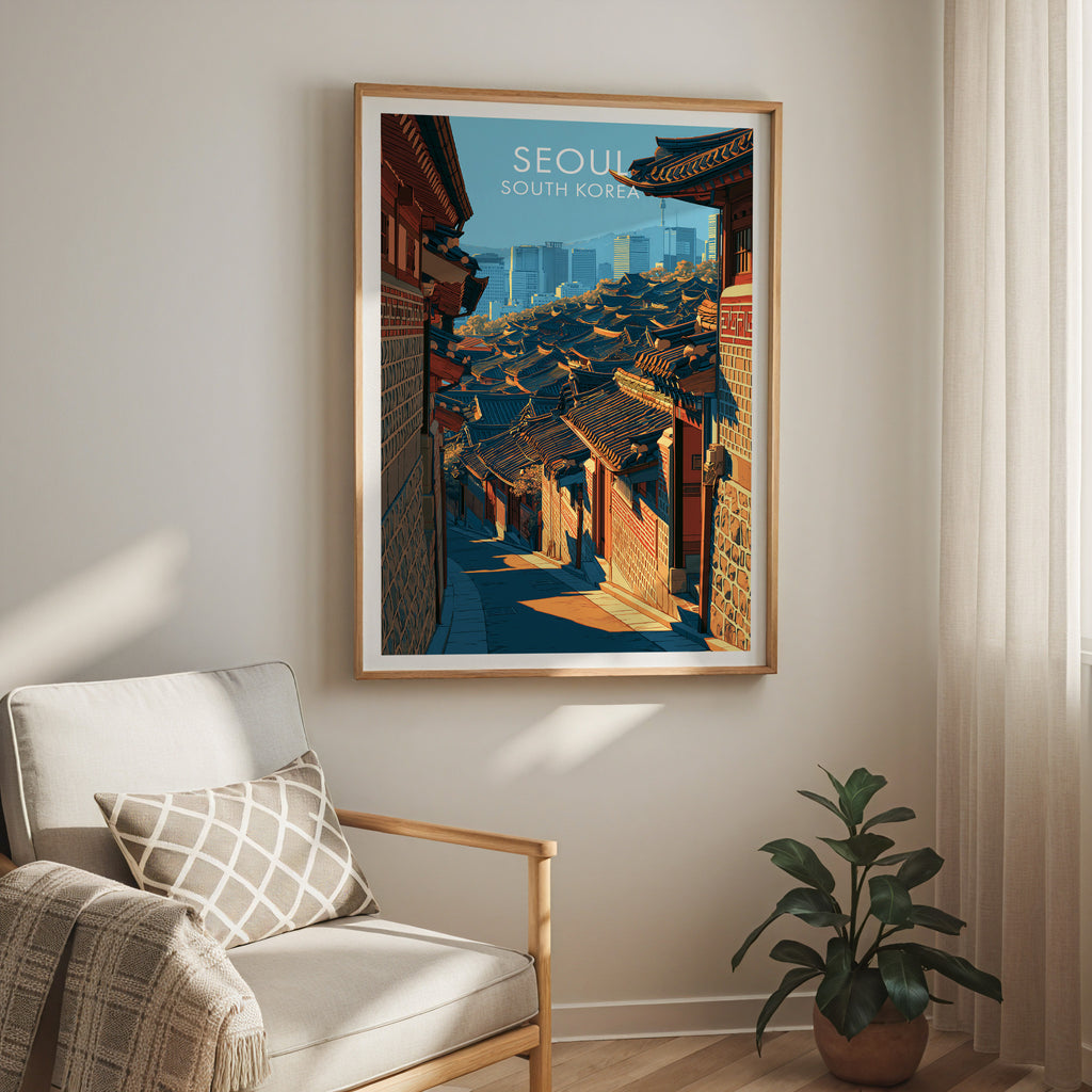 Bukchon Hanok Village Seoul travel print in a light oak frame on a living room wall beside a linen armchair