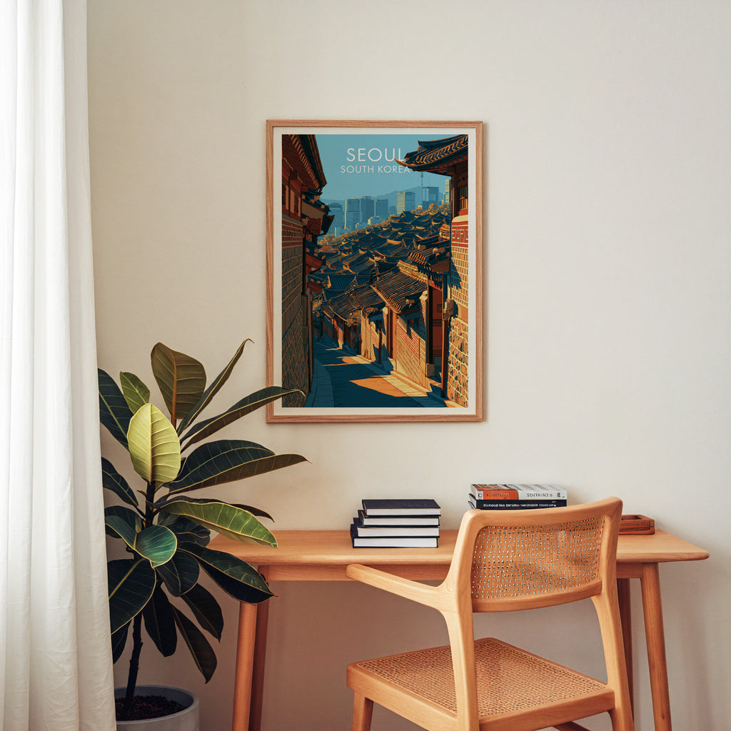 Bukchon Hanok Village Seoul wall art above a wooden home office desk with a rattan chair and books