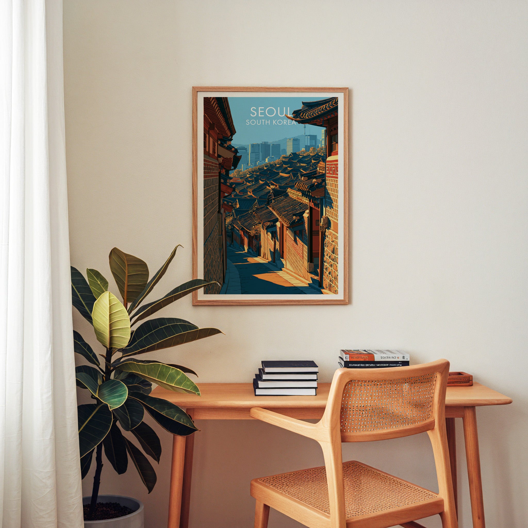 Bukchon Hanok Village Seoul wall art above a wooden home office desk with a rattan chair and books