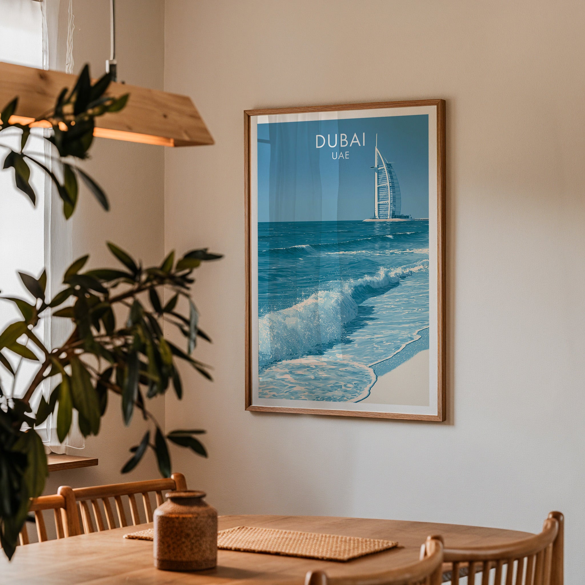 Framed Burj Al Arab Dubai UAE print on a dining room wall above an oak table in warm afternoon light