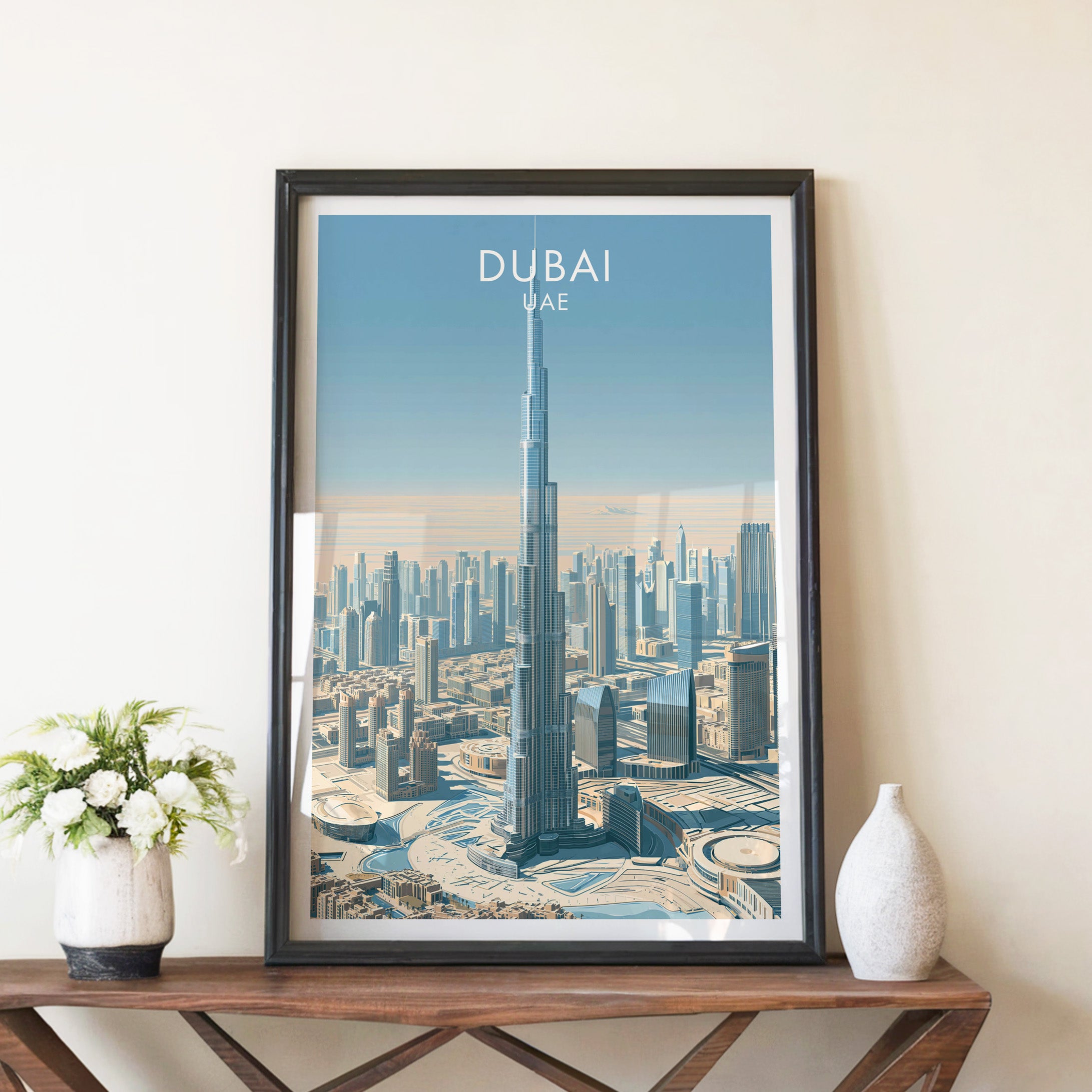 Burj Khalifa Dubai UAE travel poster in a black frame on a wooden console table with white flowers