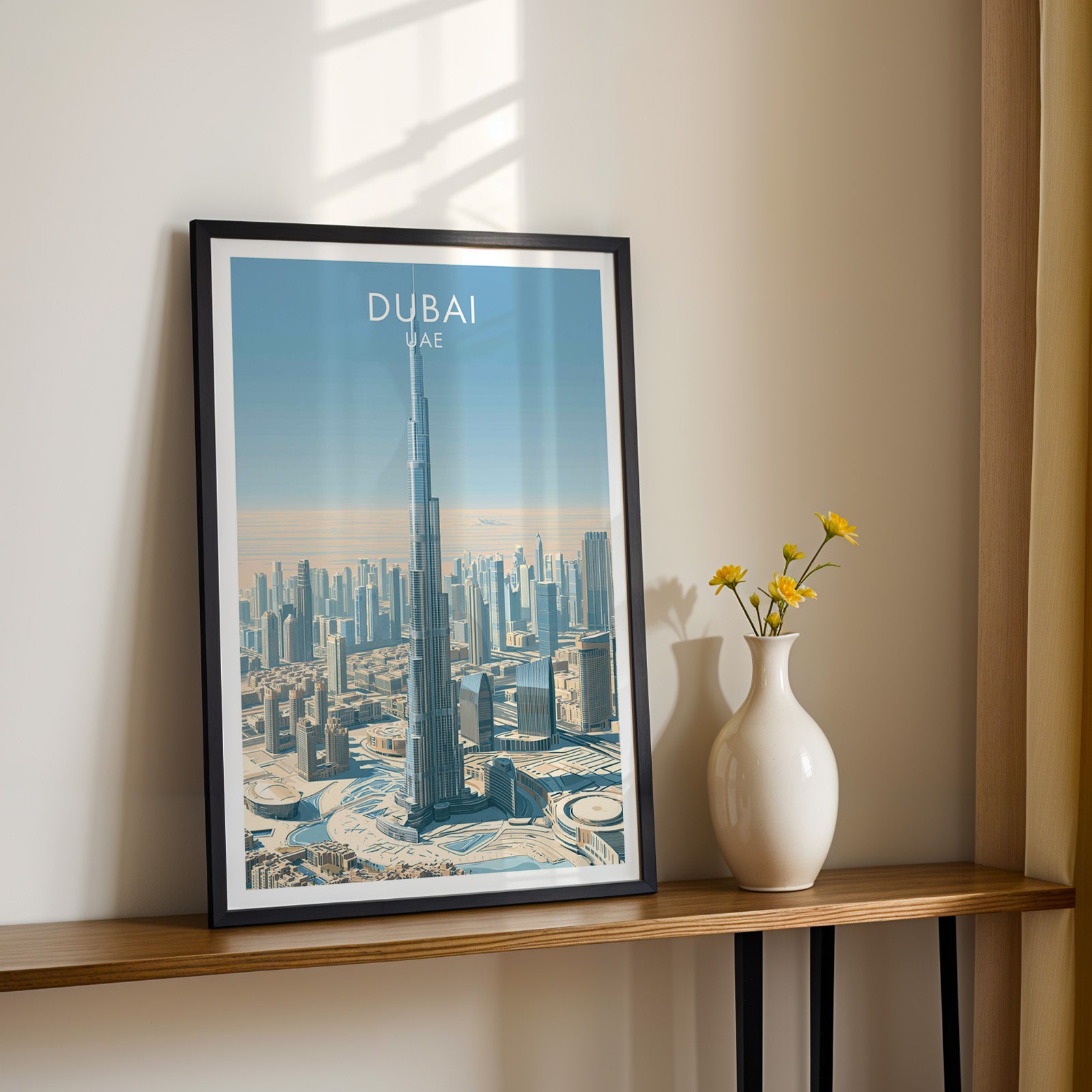 Black framed Burj Khalifa Dubai UAE print on a narrow hallway console in sunlight, styled with yellow flowers