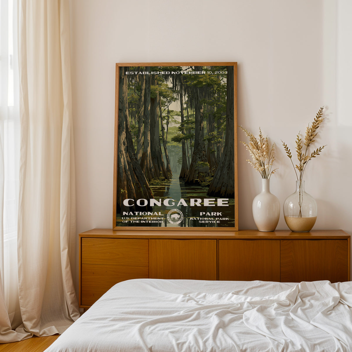 Congaree National Park retro poster above a walnut sideboard in a bright linen bedroom
