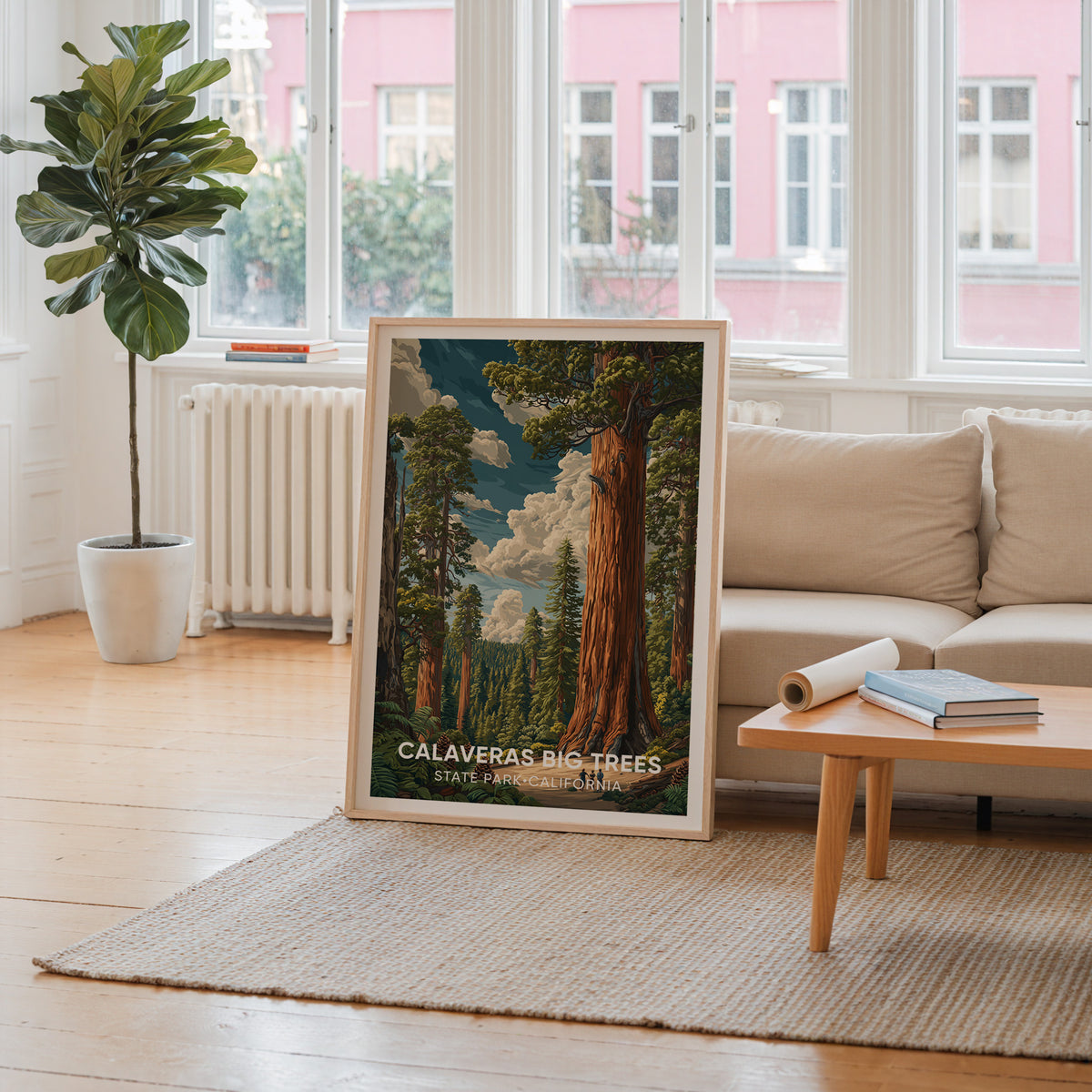 Calaveras Big Trees wall art in oak by a window framing a pink facade, cream sofa and radiator