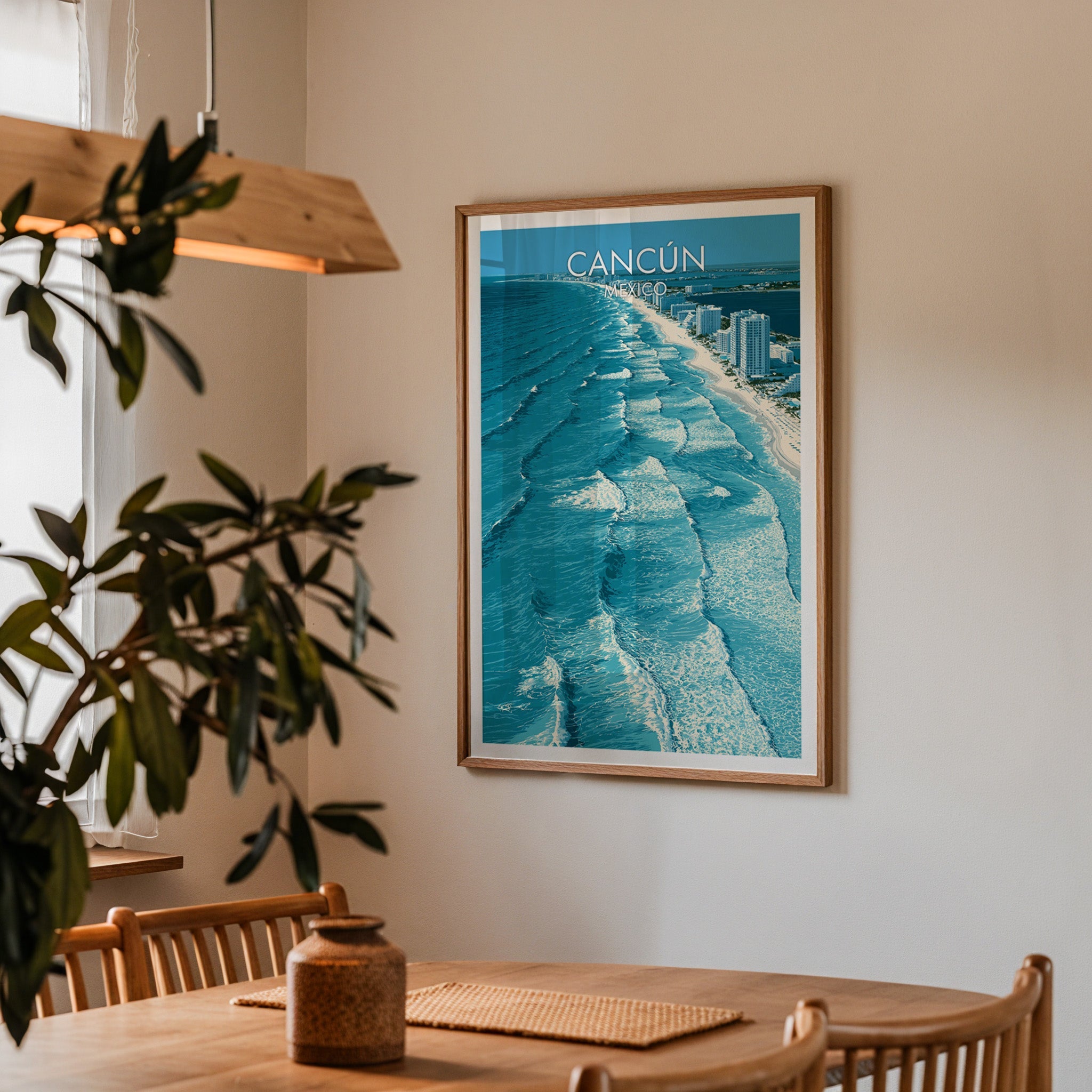 Cancun coastline print in an oak frame in a dining corner with spindle chairs and a wood pendant lamp.