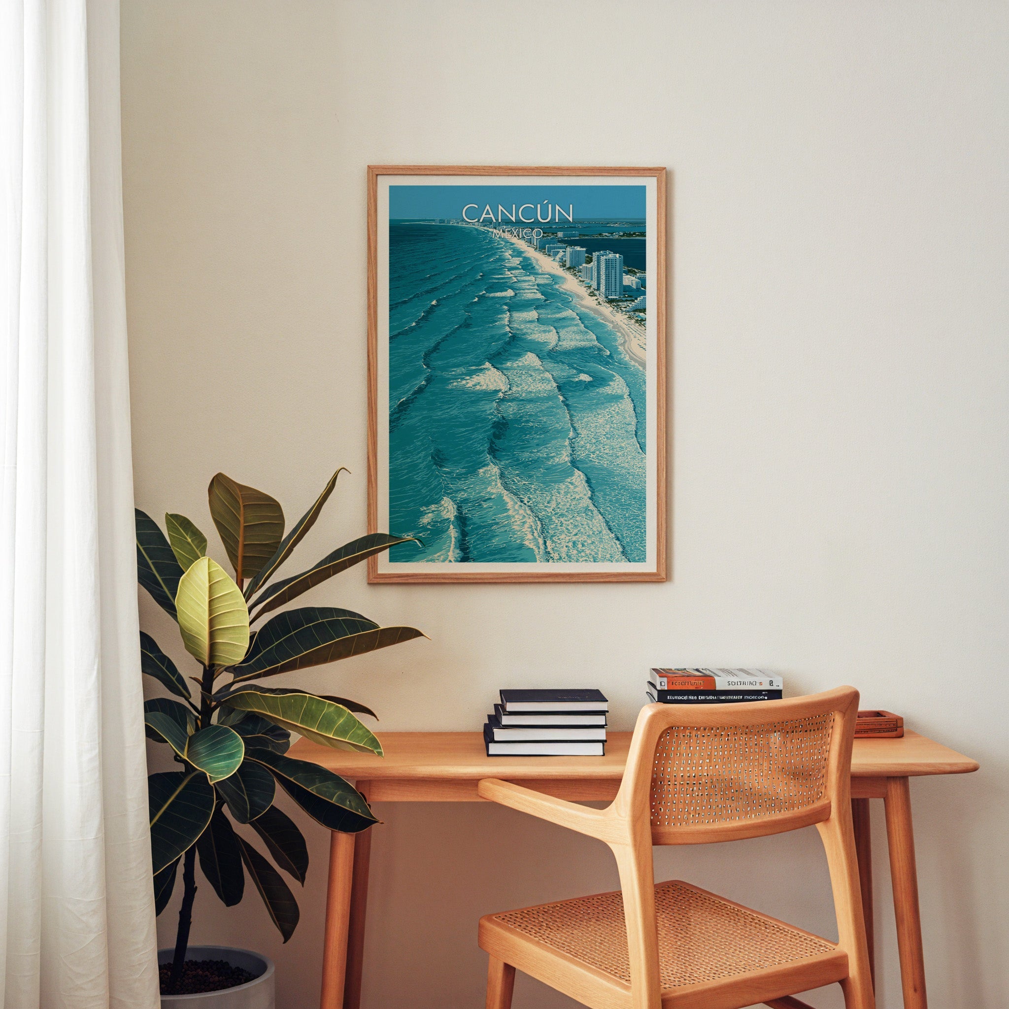 Surf and sand strip poster in an oak frame above a wooden home-office desk with a cane chair.