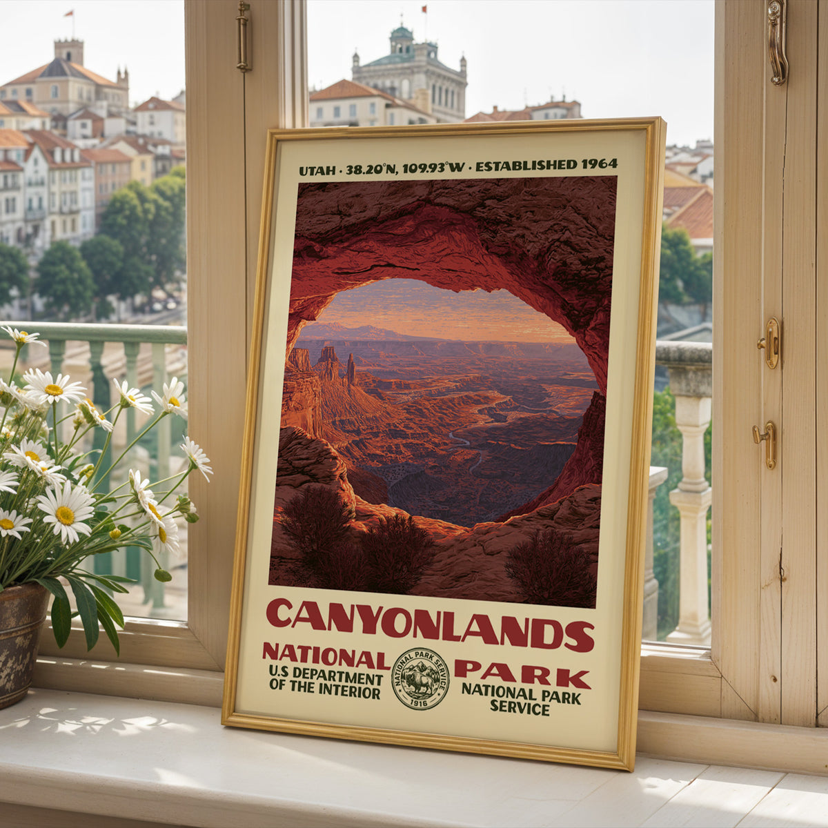 Canyonlands National Park poster framed on a sunlit windowsill with fresh daisies and a bright view