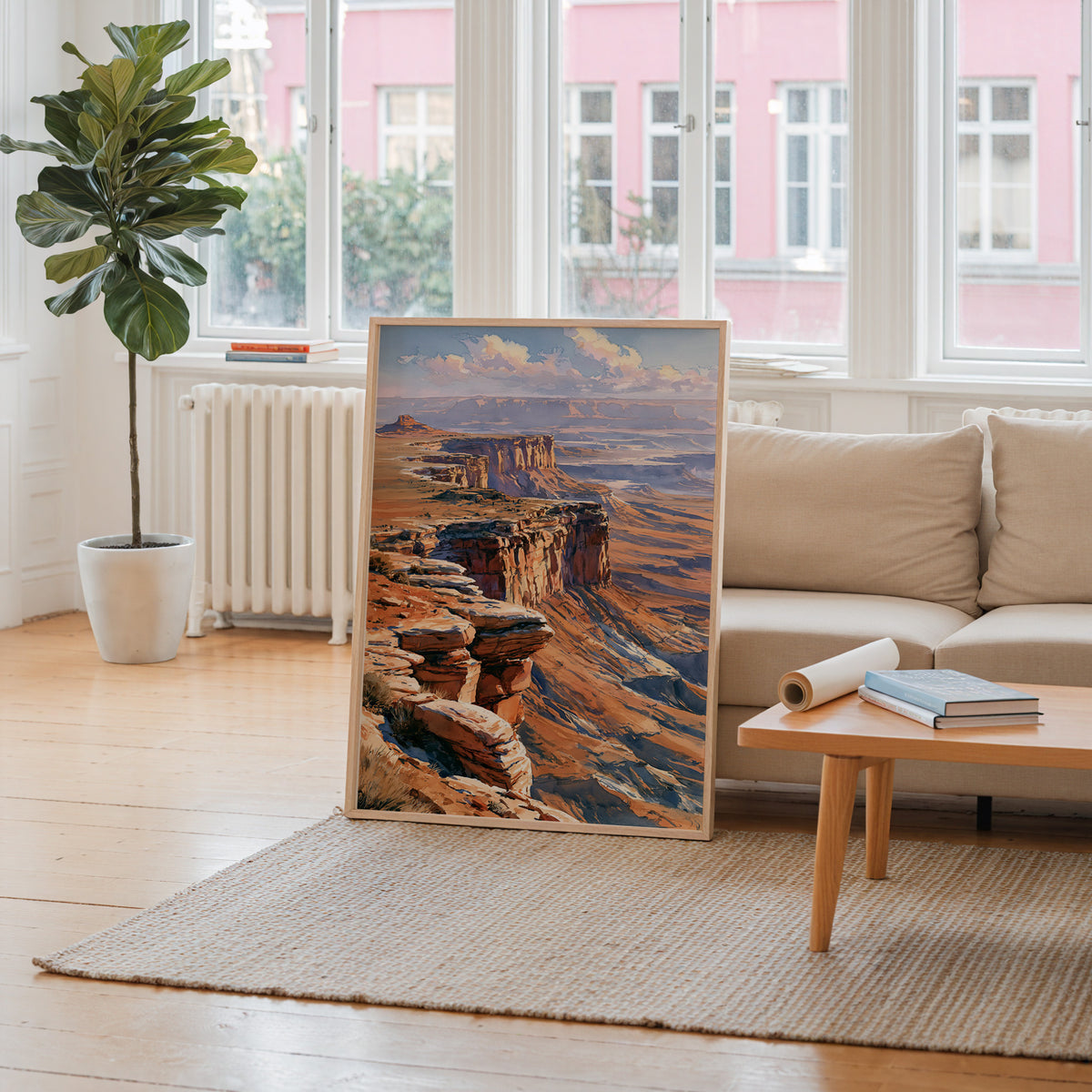 Canyonlands National Park watercolor art print leaning against a living room wall beside a linen sofa and coffee table