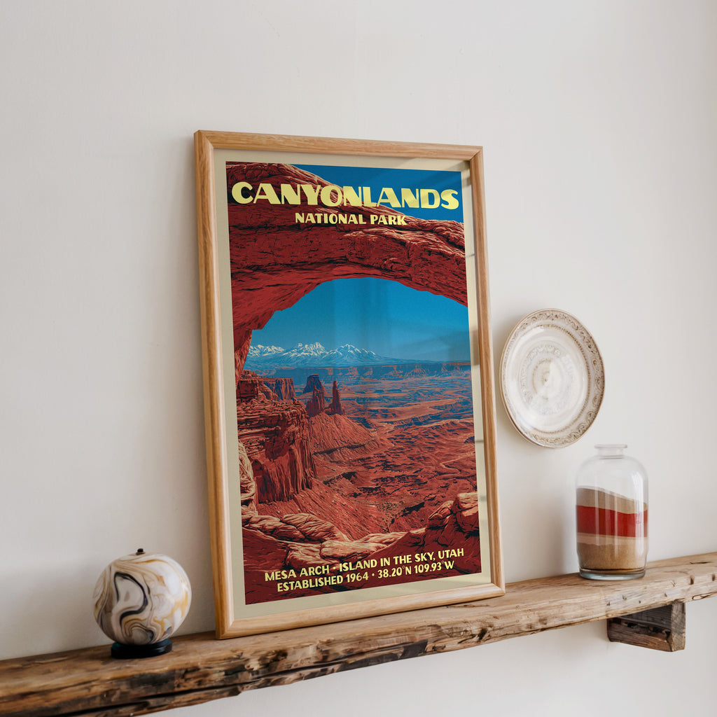 Canyonlands Mesa Arch print in oak, leaning on a reclaimed wood ledge with a stone sphere and sand jar