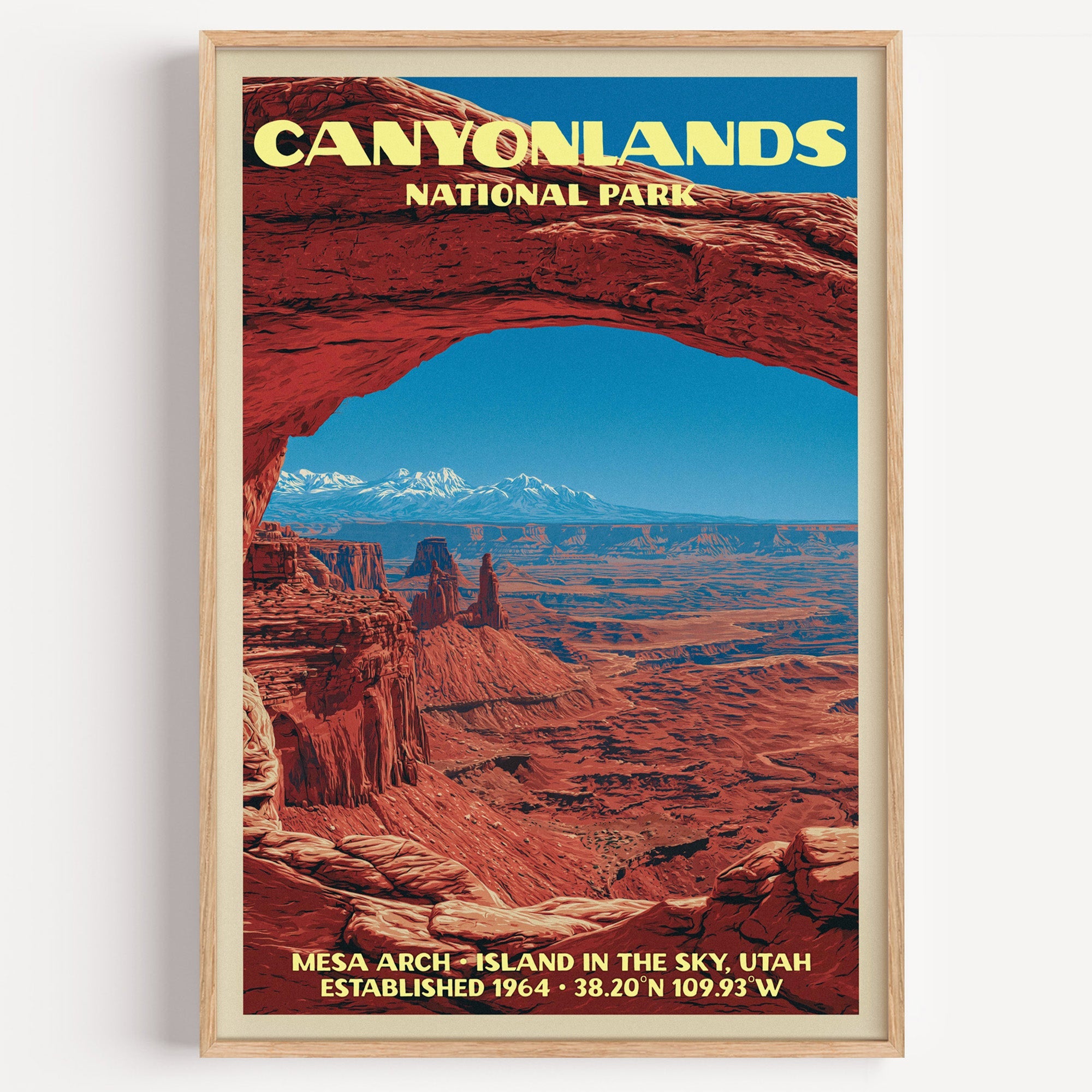 Mesa Arch Canyonlands National Park vintage poster in a light oak frame on a plain white wall