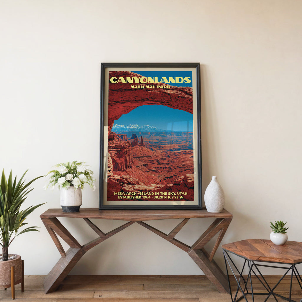 Canyonlands Mesa Arch wall art in black, leaning on a walnut console with white anemones and a vase