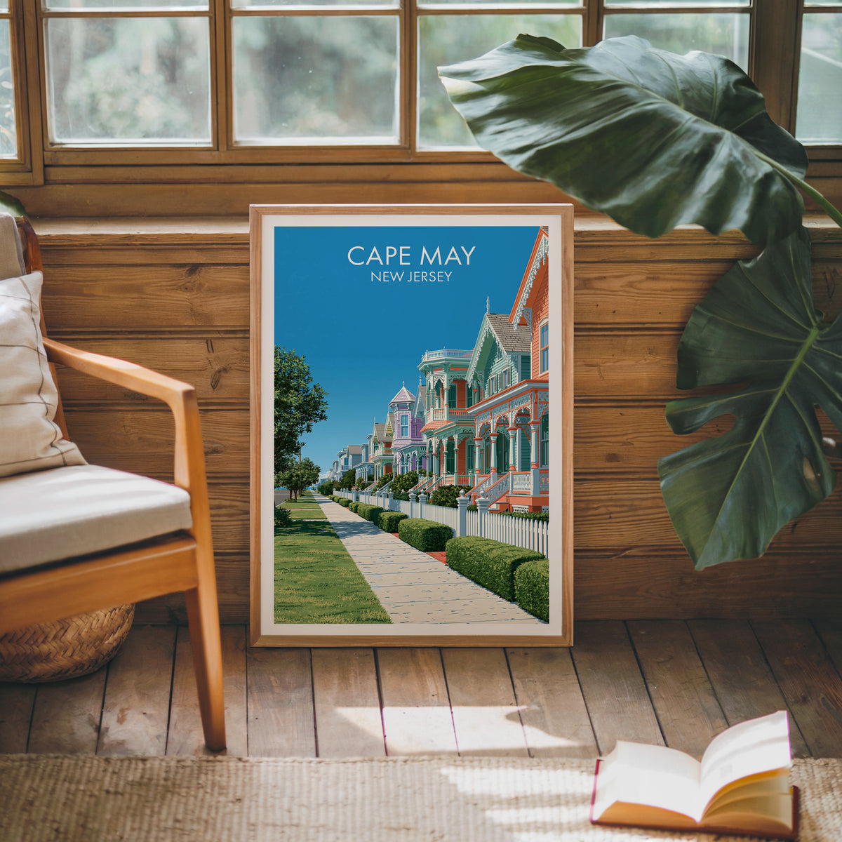 Cape May canvas print in an oak frame on a sunlit wood wall beside a mid-century armchair and rug