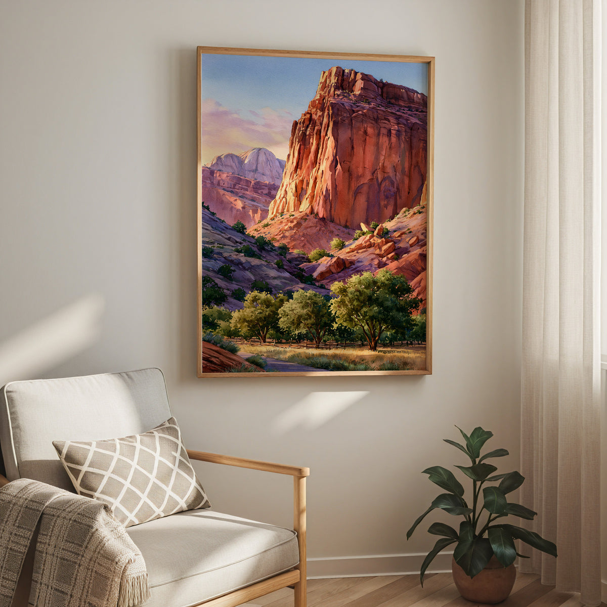 Oak-framed Capitol Reef National Park watercolor print hung above a cream armchair in a bright living room