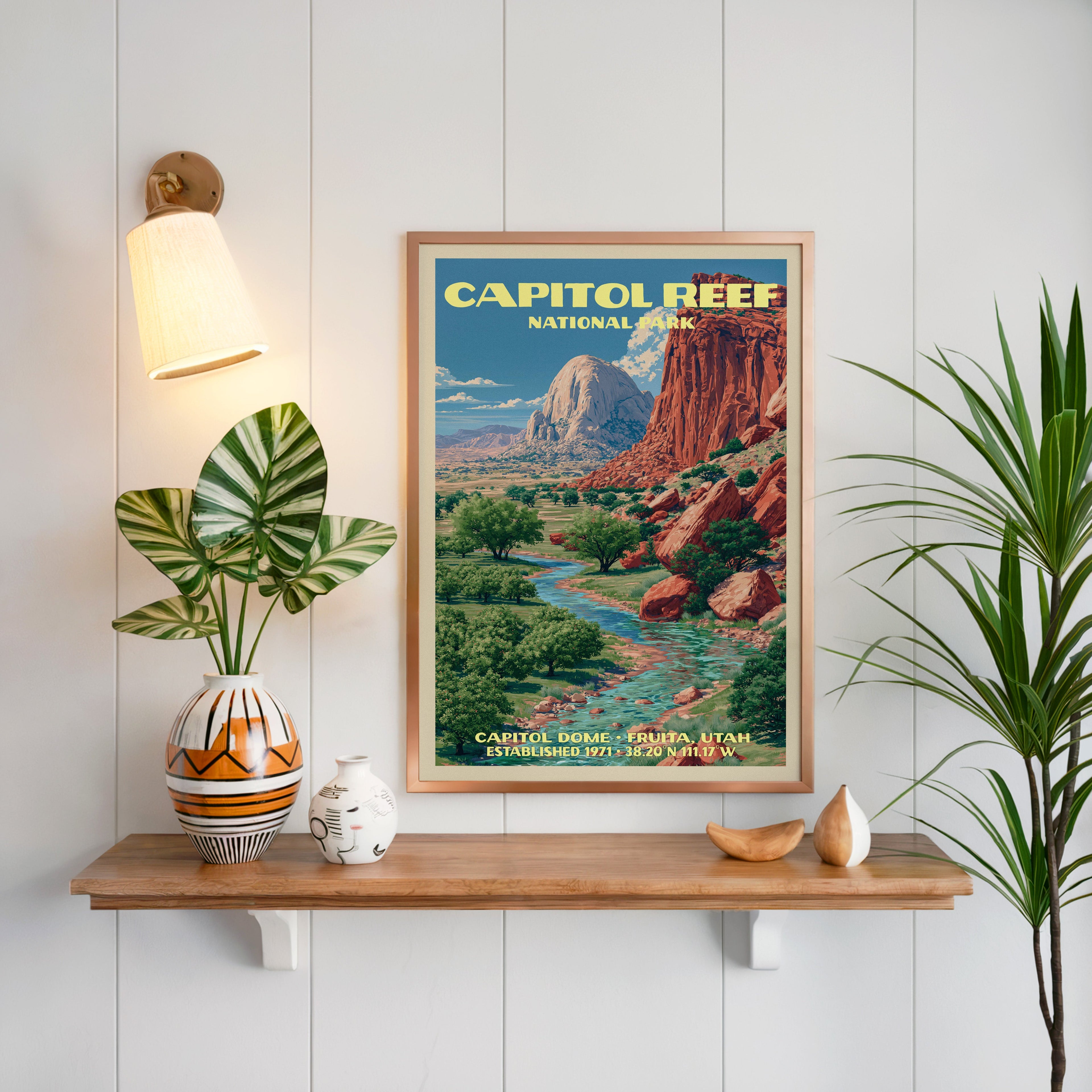 Capitol Dome Capitol Reef print framed on white panelling above an oak shelf with a patterned vase and sconce