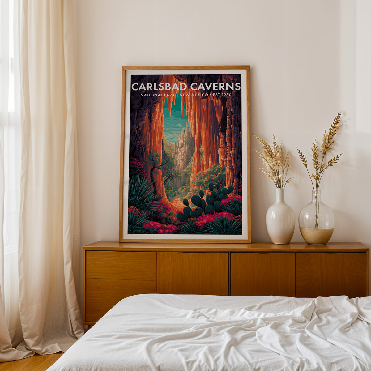 Carlsbad Caverns National Park mid-century modern art print framed in oak and propped on a walnut credenza beside a linen-dressed bed — bedroom wall art