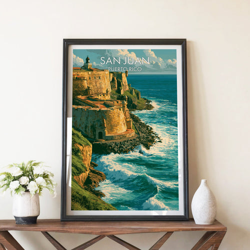 San Juan fort ramparts in a black frame on a walnut console with white peonies in a stone vase and a white vase