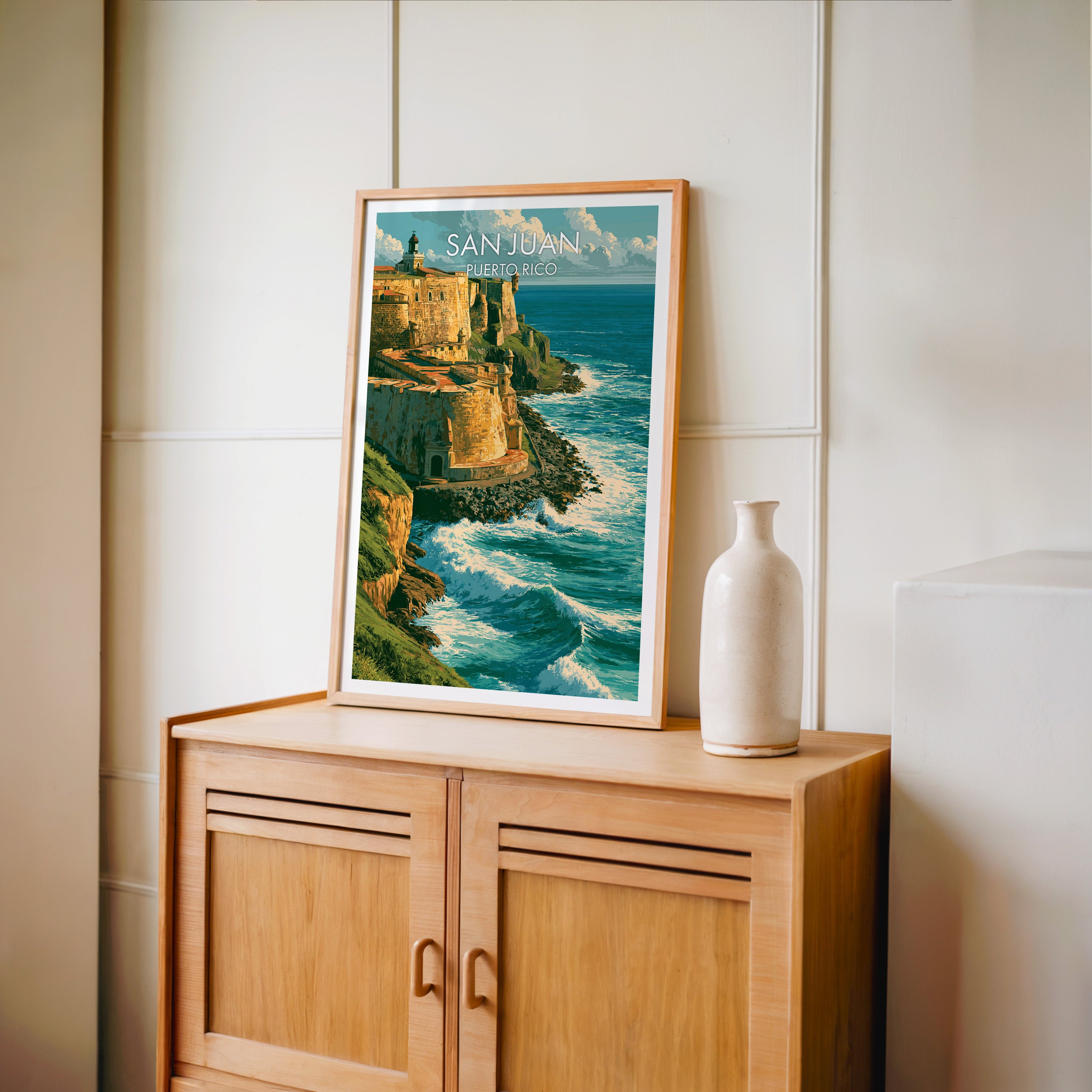 Tiered fort ramparts in an oak frame on a light oak cabinet, cream panelled wall and a tall pale bottle vase
