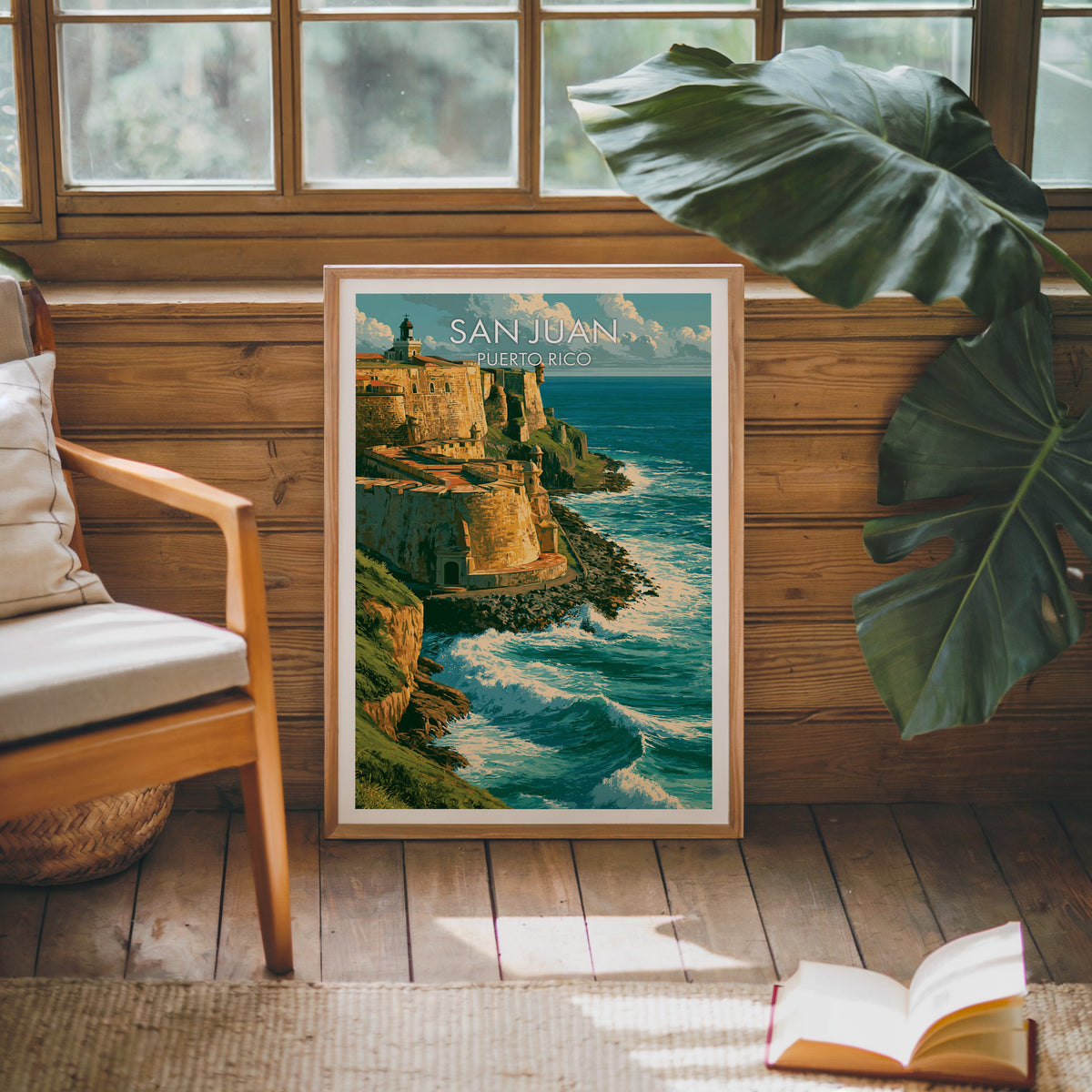 Caribbean coast art in an oak frame leaning on a pine cabin wall with a wooden armchair and a monstera leaf