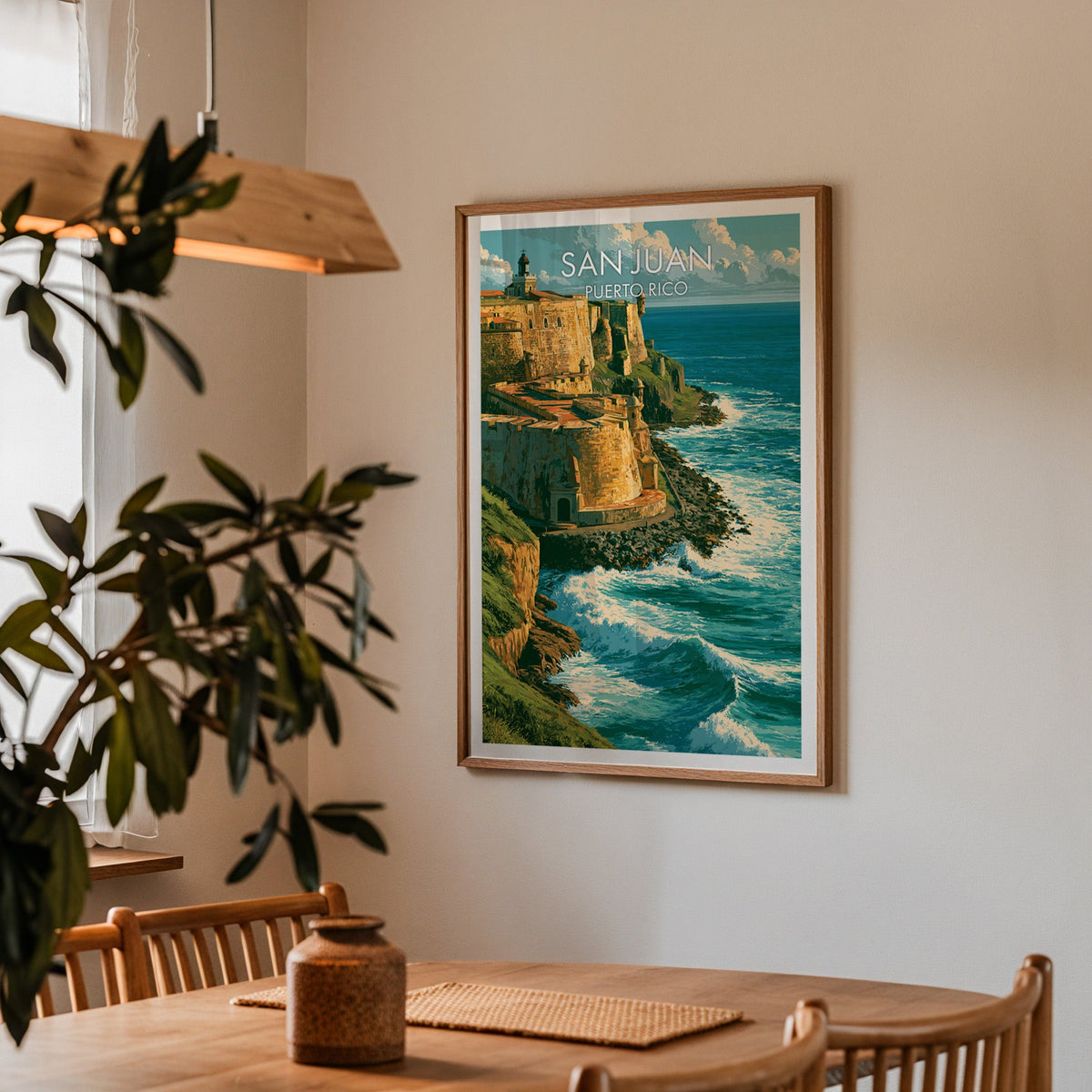 Green headland and fort walls in an oak frame in a dining corner with an oak table and a wood pendant lamp