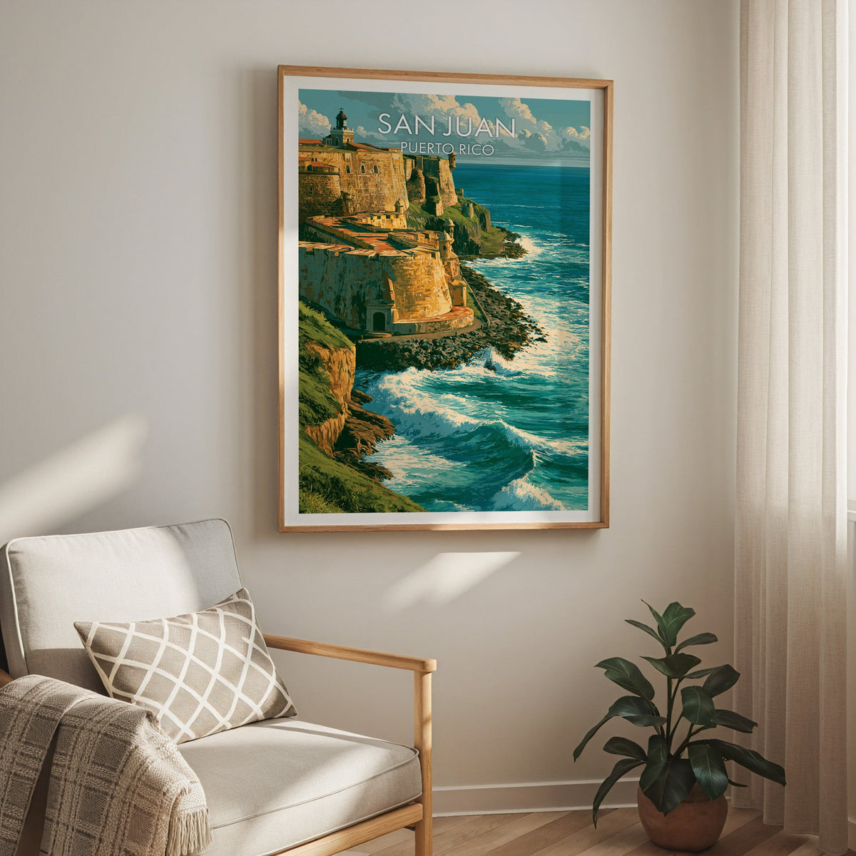 San Juan coastline scene in an oak frame above a cream armchair with a check cushion and a sheer curtain
