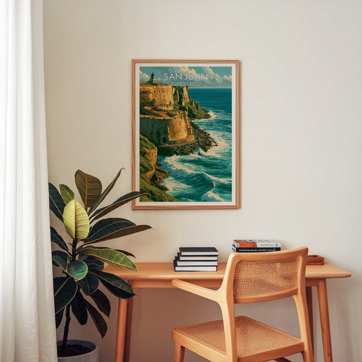Teal and gold fortress print in an oak frame above a home-office desk with a cane chair and a rubber plant
