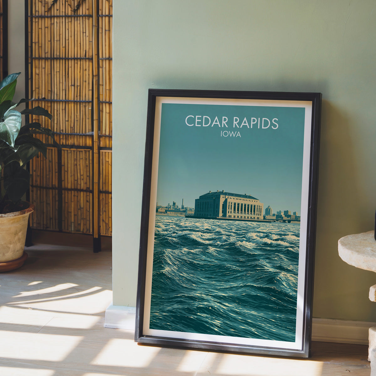 Cedar River waves print in a black frame beside a sage wall with a bamboo screen and orchid
