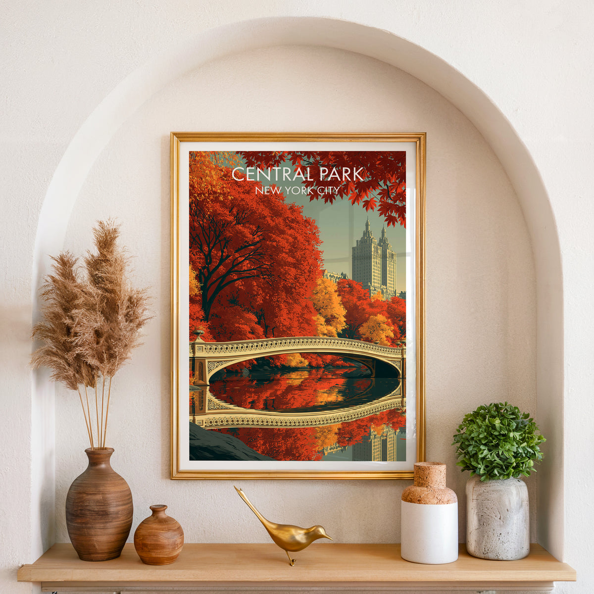 Bow Bridge wall art in a gold frame in an arched alcove with pampas grass and a wood shelf