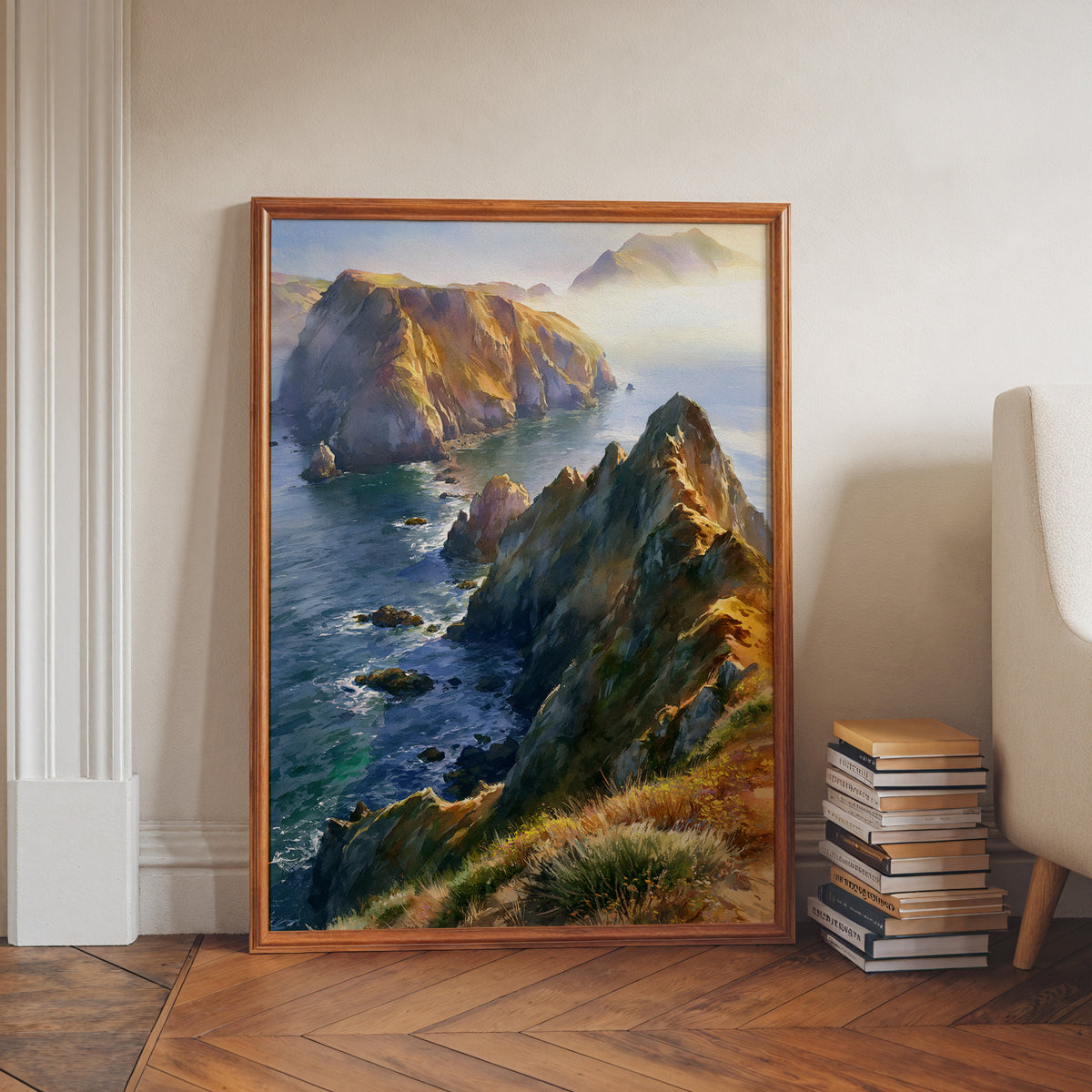 Channel Islands National Park watercolor print in a walnut frame leaning on a herringbone floor beside stacked books