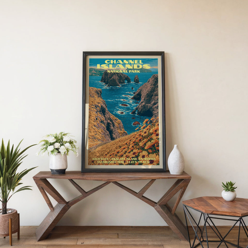 Channel Islands Arch Rock wall art in black, leaning on a walnut console with white anemones and a vase