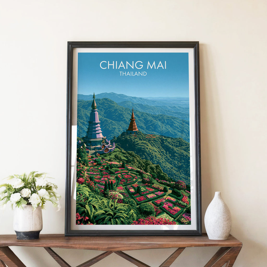 Chiang Mai Thailand travel poster in a black frame on a wooden console table with white flowers