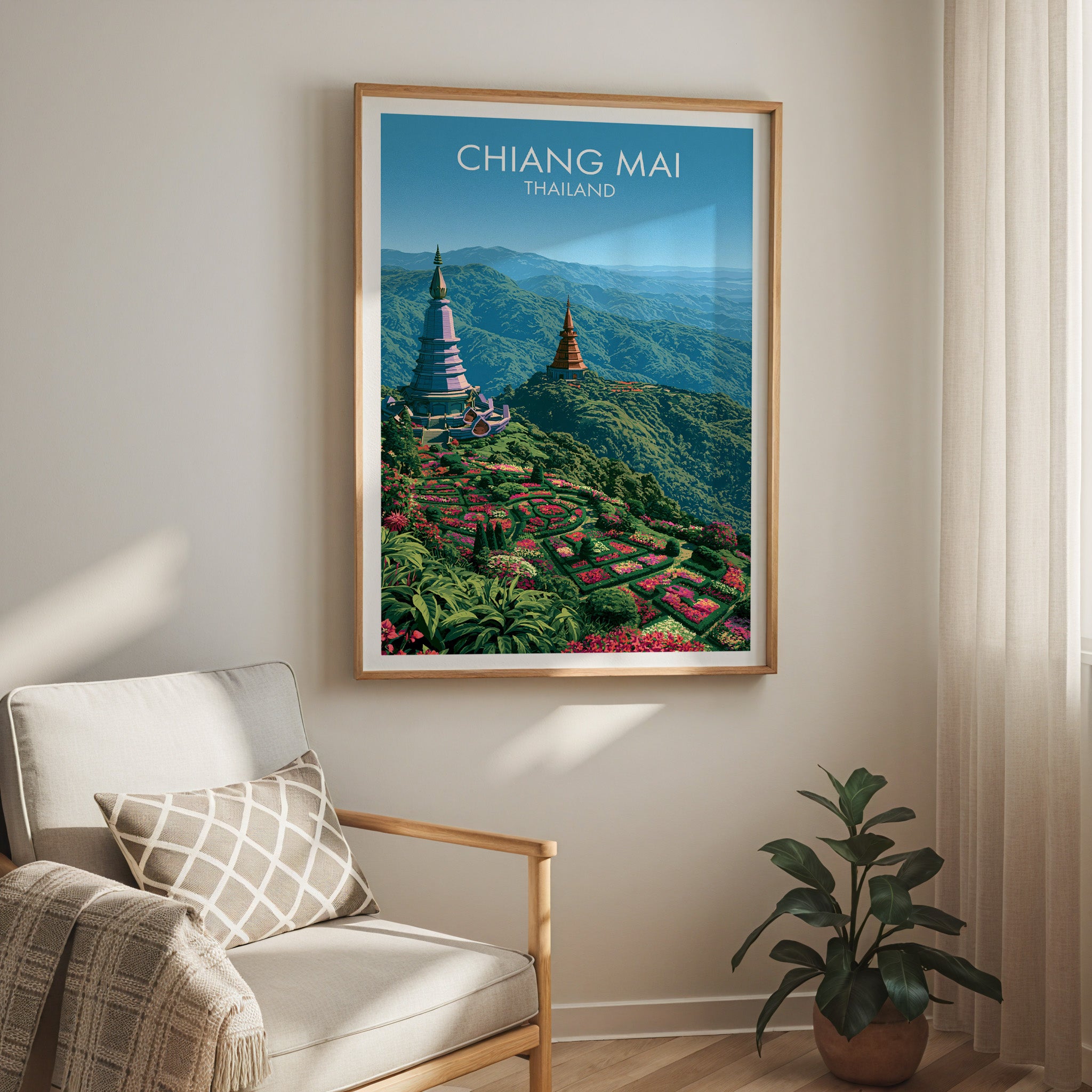Chiang Mai Thailand travel print in a light oak frame on a living room wall beside a linen armchair
