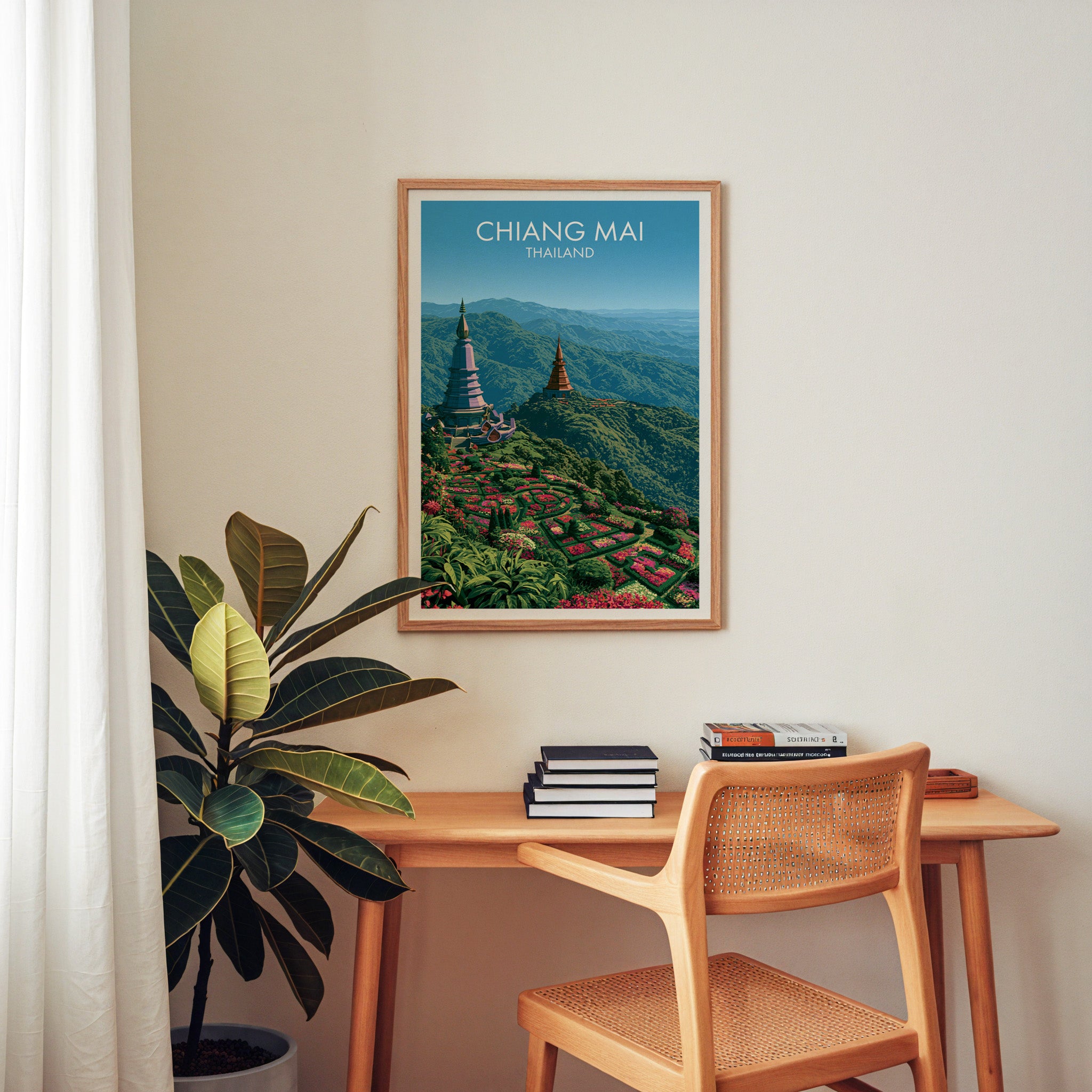 Chiang Mai Thailand wall art above a wooden home office desk with a rattan chair and books