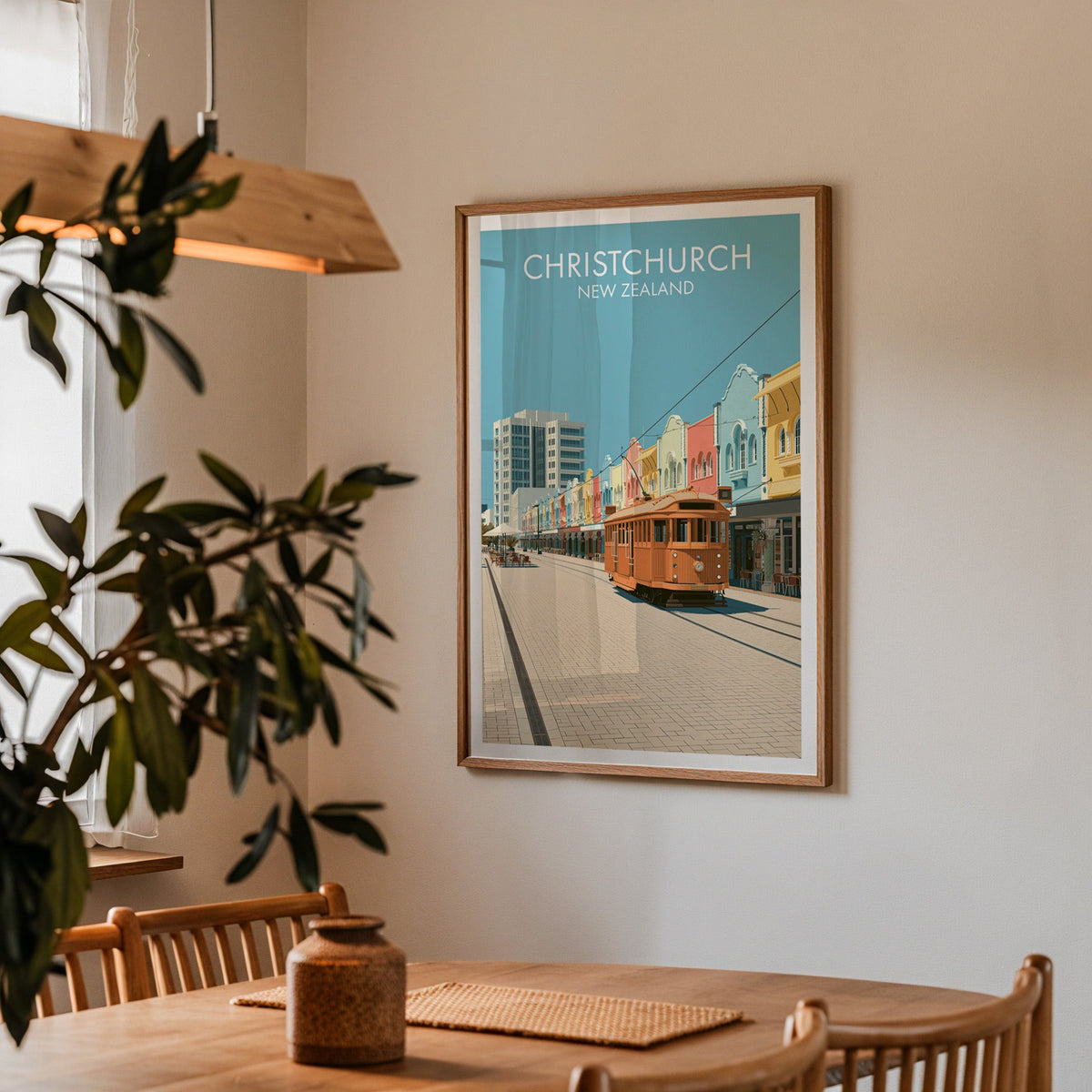 Canterbury city poster in a dining corner with an oak table, spindle chairs and a wood pendant light