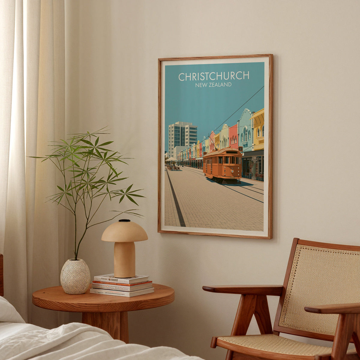 Tram and shopfronts artwork in a bedroom above a round bedside table with a mushroom lamp and bamboo