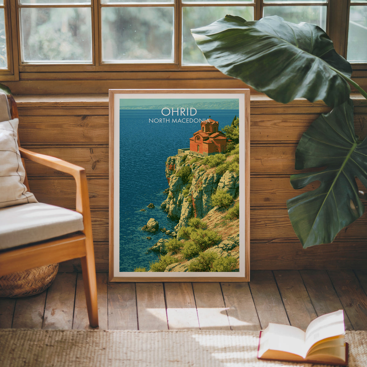 Church of St John Kaneo poster, oak frame leaning on a wood-panelled sunroom wall by a mid-century armchair